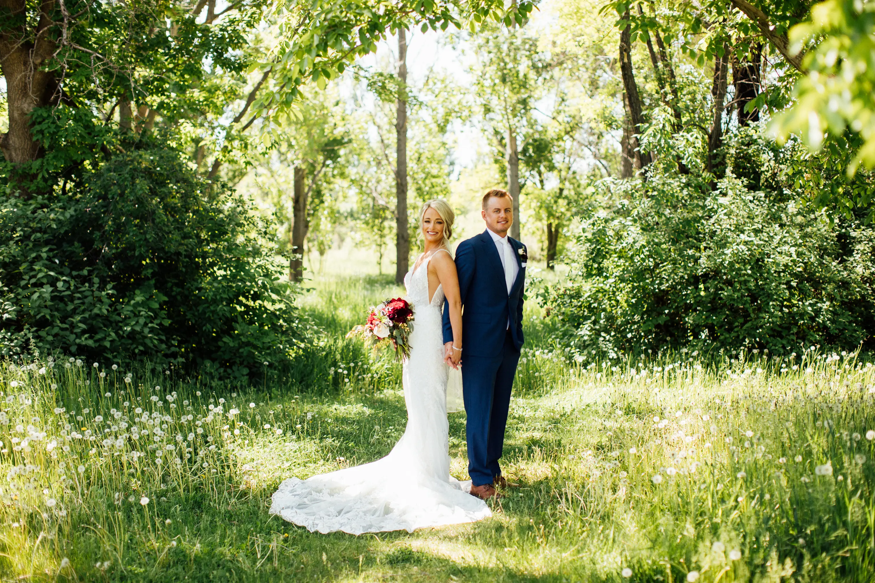 Bride Wearing Graceful Sparkly Lace Wedding Dress Called Fontaine By Maggie Sottero Stands Back to Back With Groom