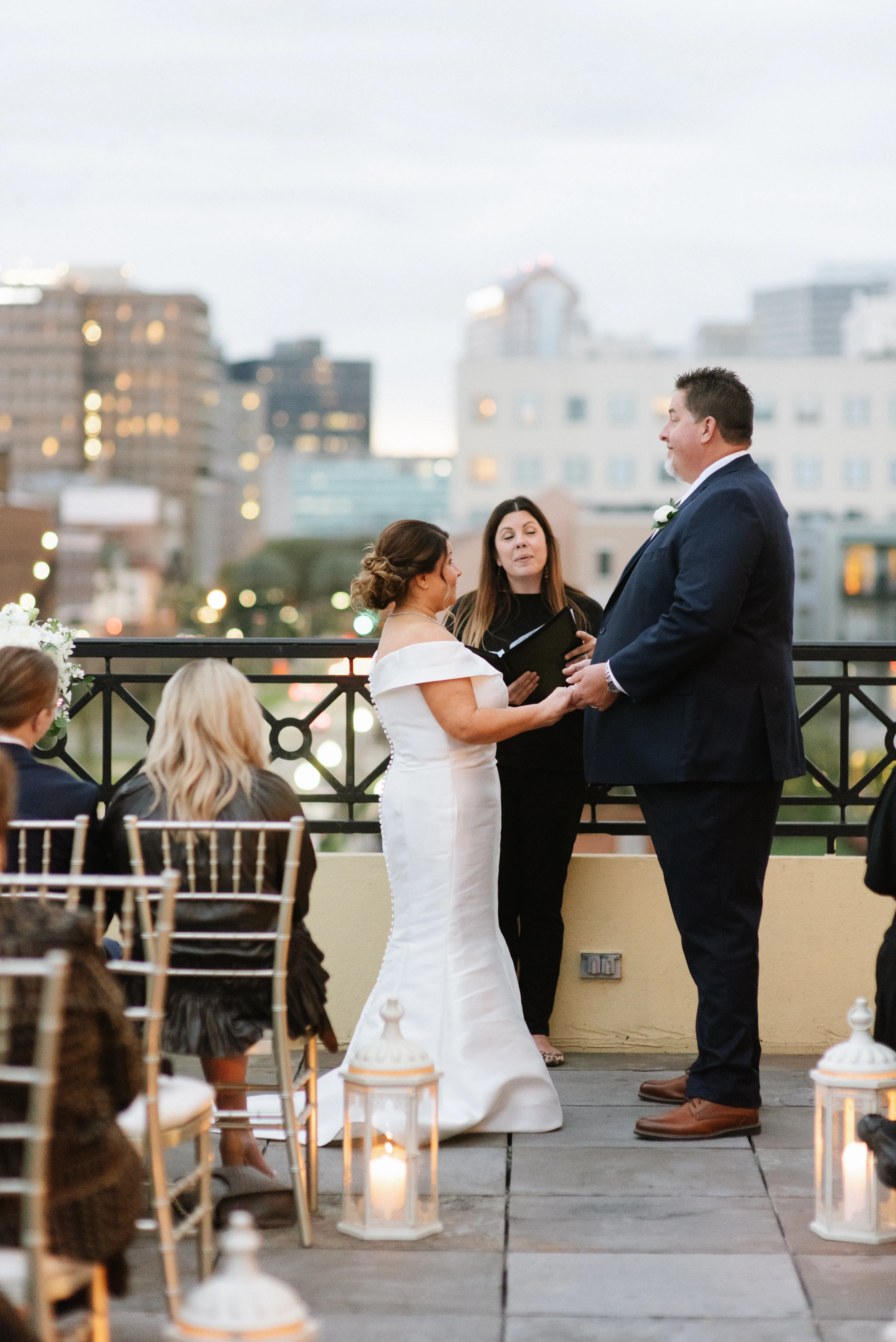 Bride with groom wearing elegant off the shoulder wedding dress