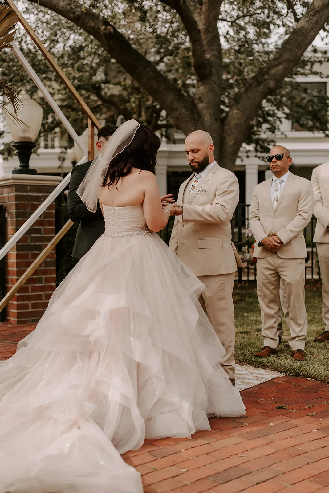 Bride with groom wearing strapless tulle ballgown wedding dress