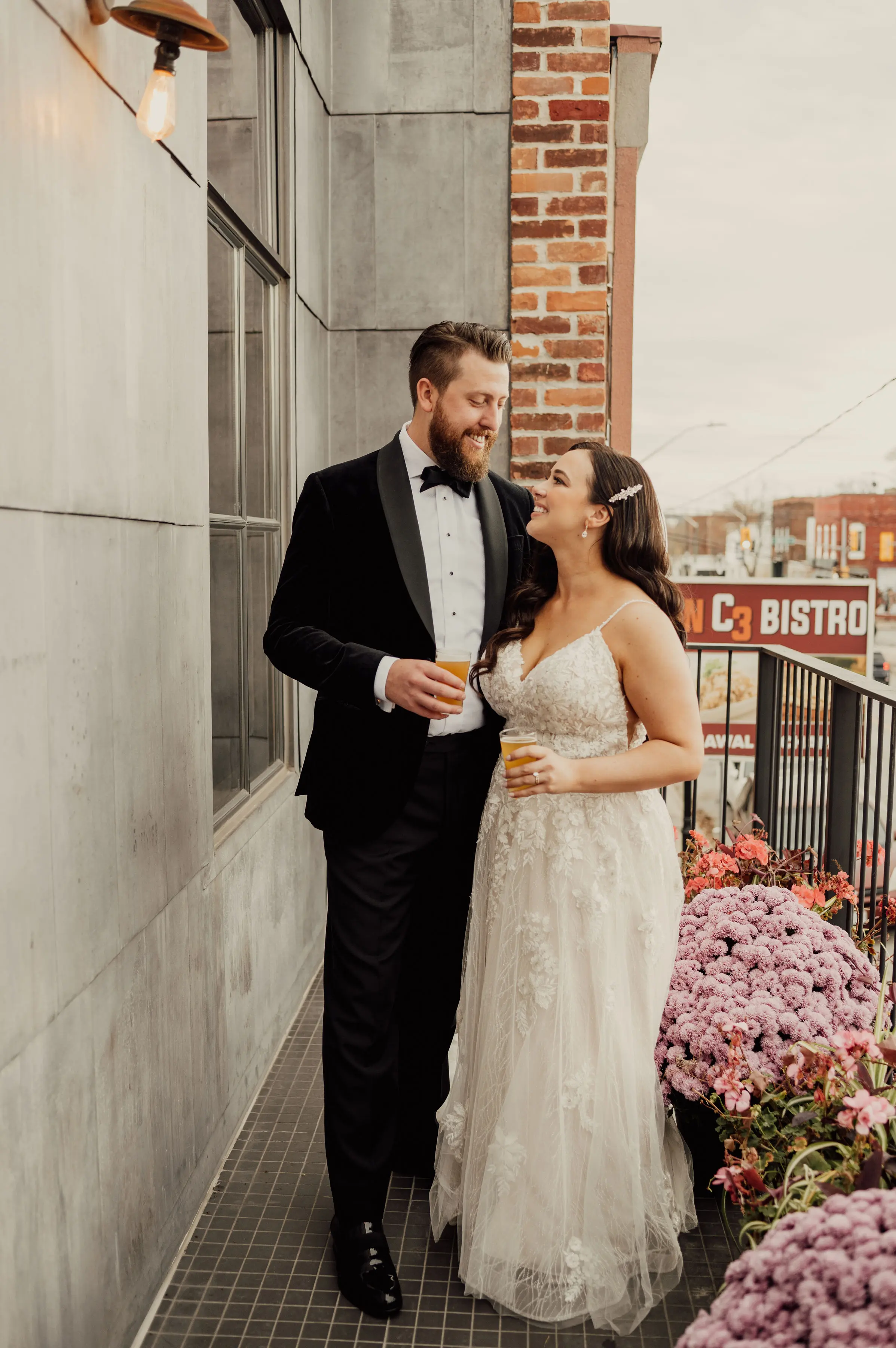 Bride Wearing Floral Lace Wedding Gown Called Laramie By Sottero And Midgley Drinking Beer With Groom