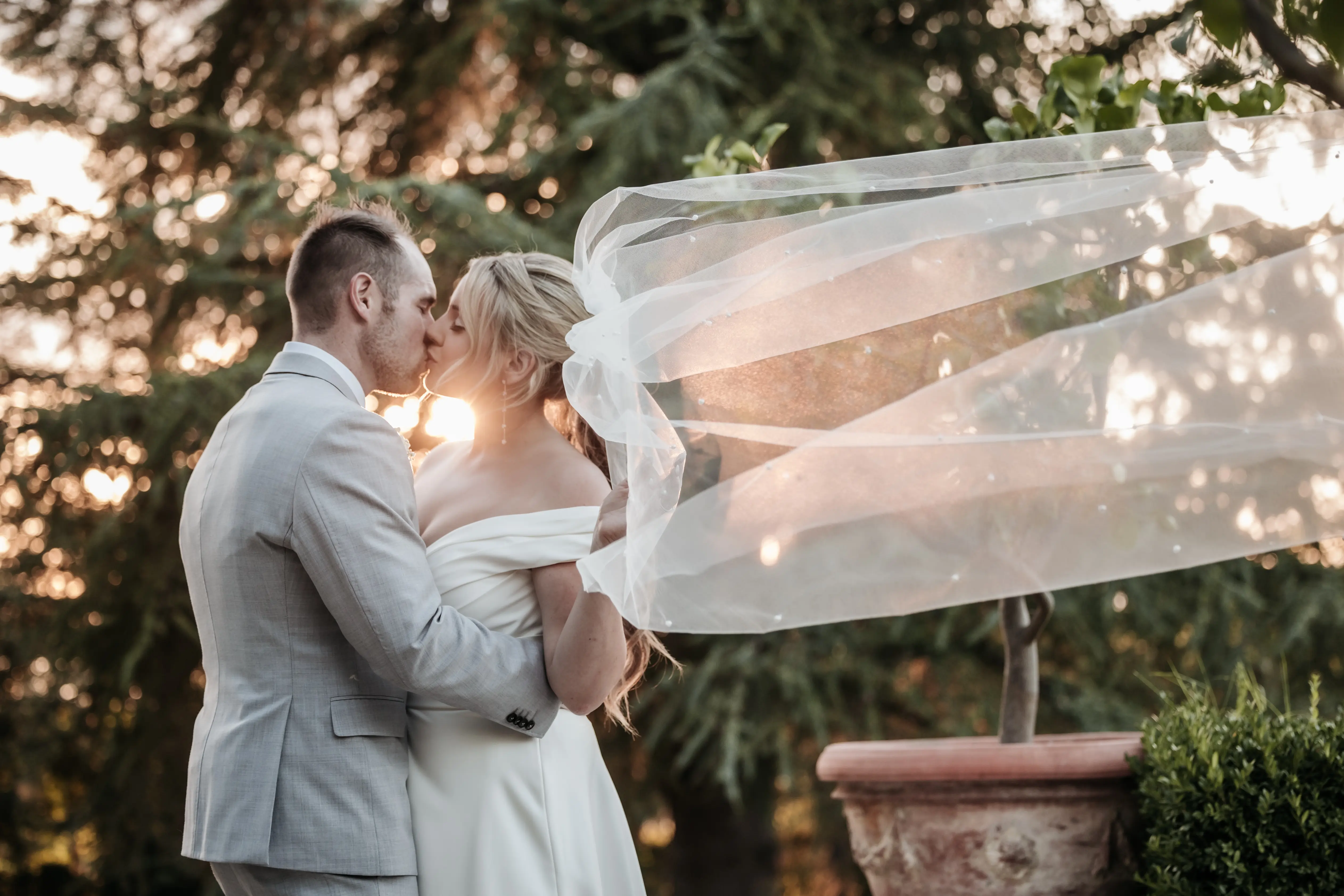 Groom With Bride Wearing A-Line Satin Off-The-Shoulder Satin Wedding Dress Ekaterina By Maggie Sottero