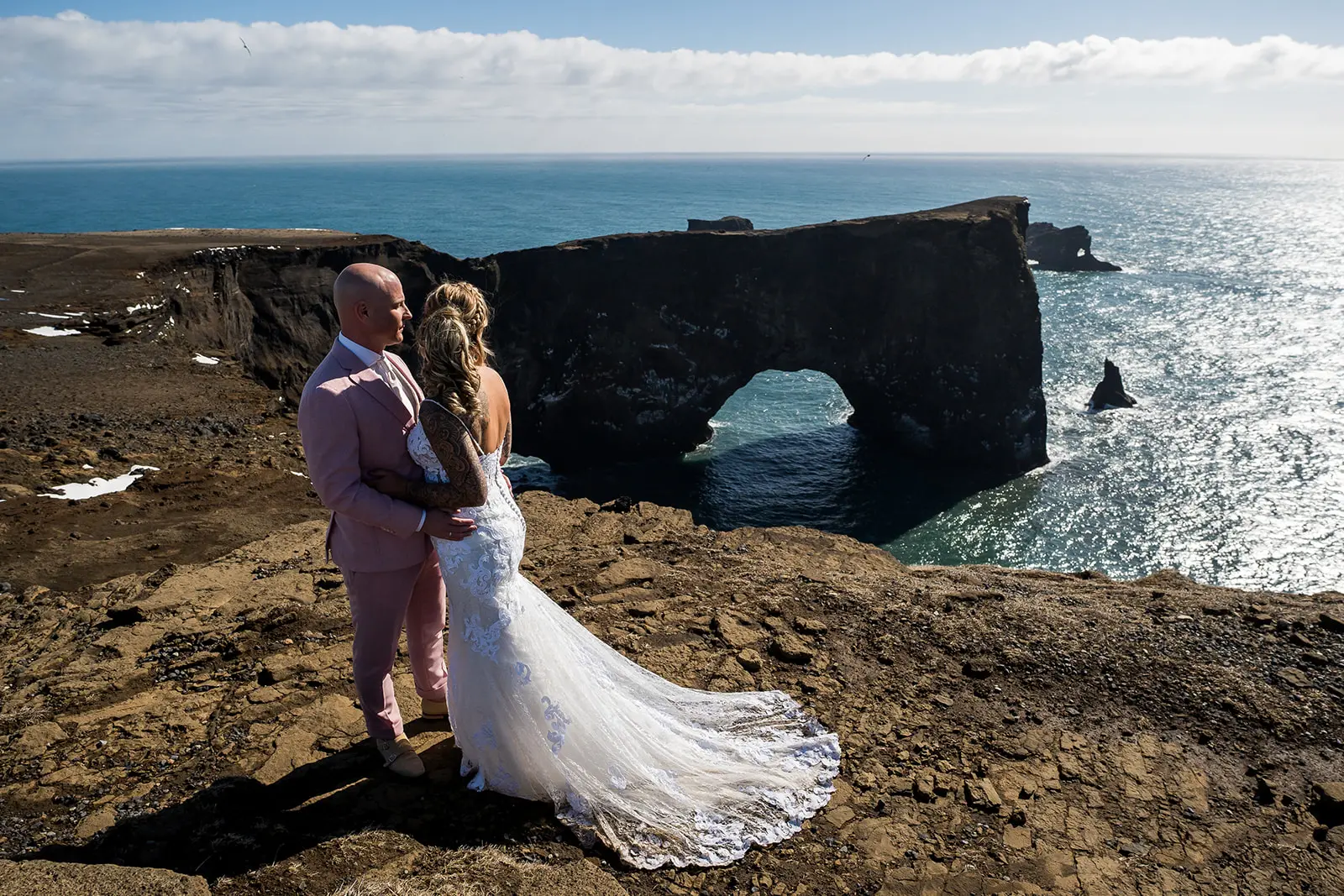 Bride wearing Tuscany Lynette by Maggie Sottero with her husband on a cliff