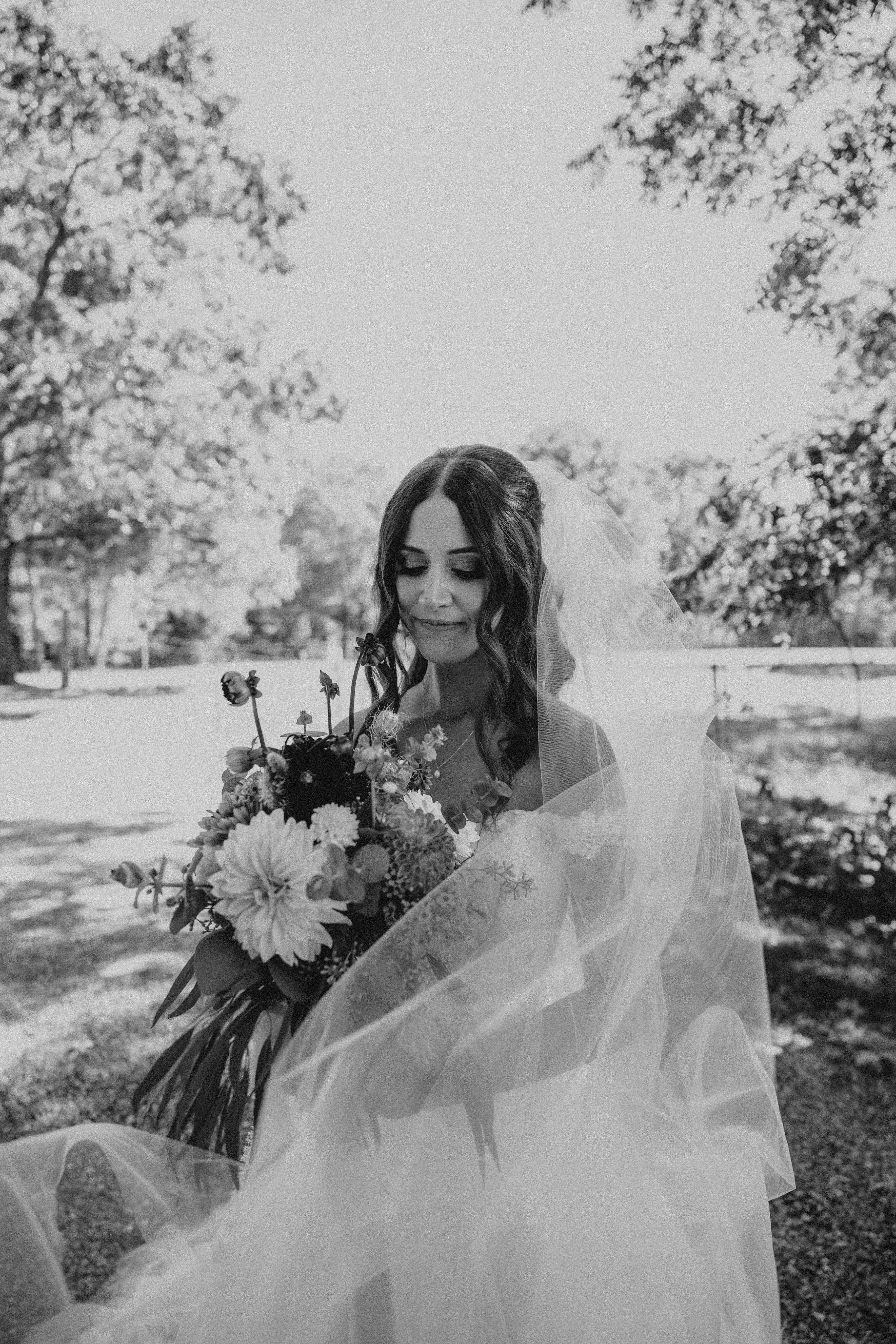 Bride wearing Harlem wedding dress by Maggie Sottero with her veil and boquet