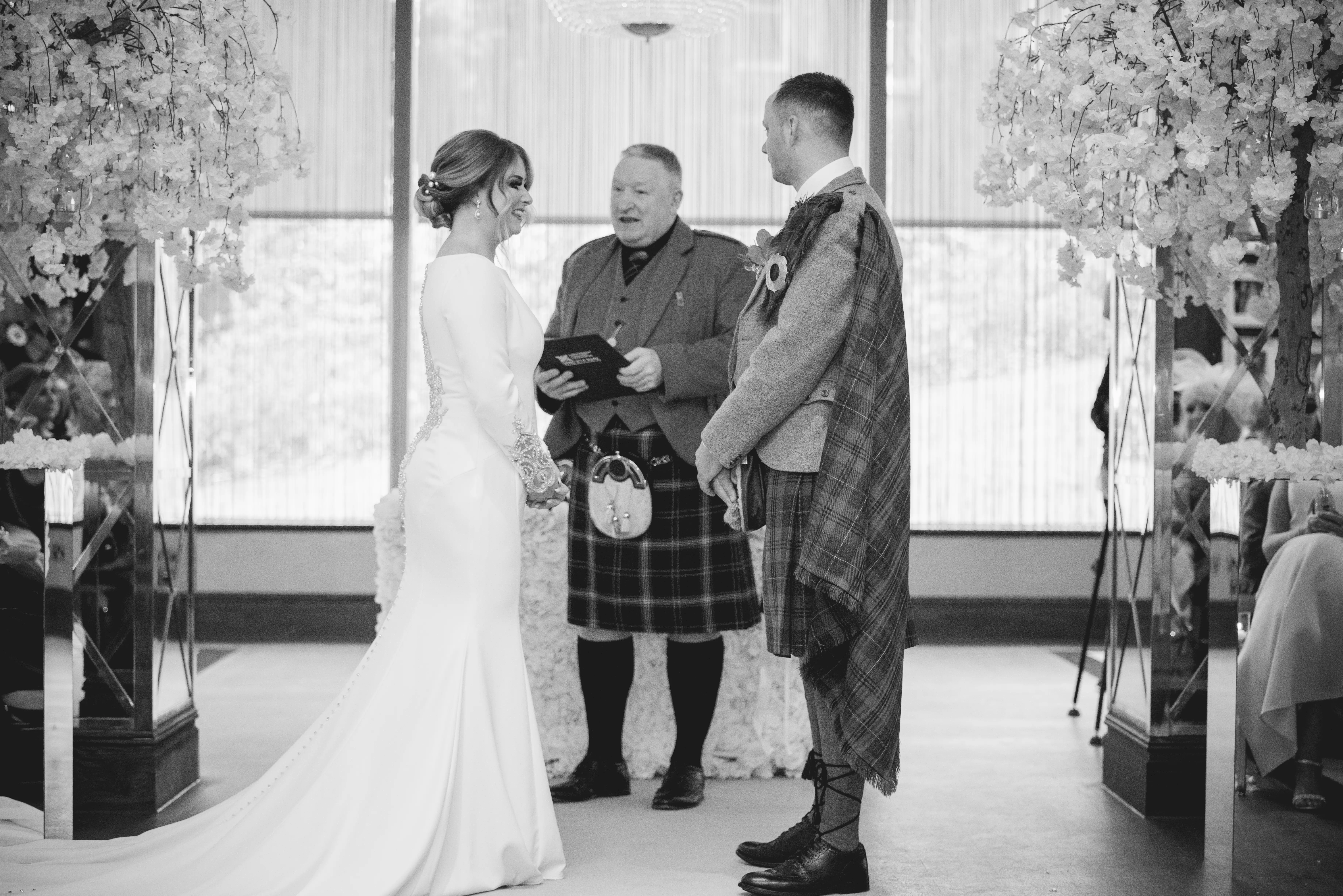 Groom at Altar with Bride in Crepe Fit-and-Flare Wedding Dress with Beaded Illusion Embroidery Featuring Swarovski Crystals Called Aston by Sottero & Midgley