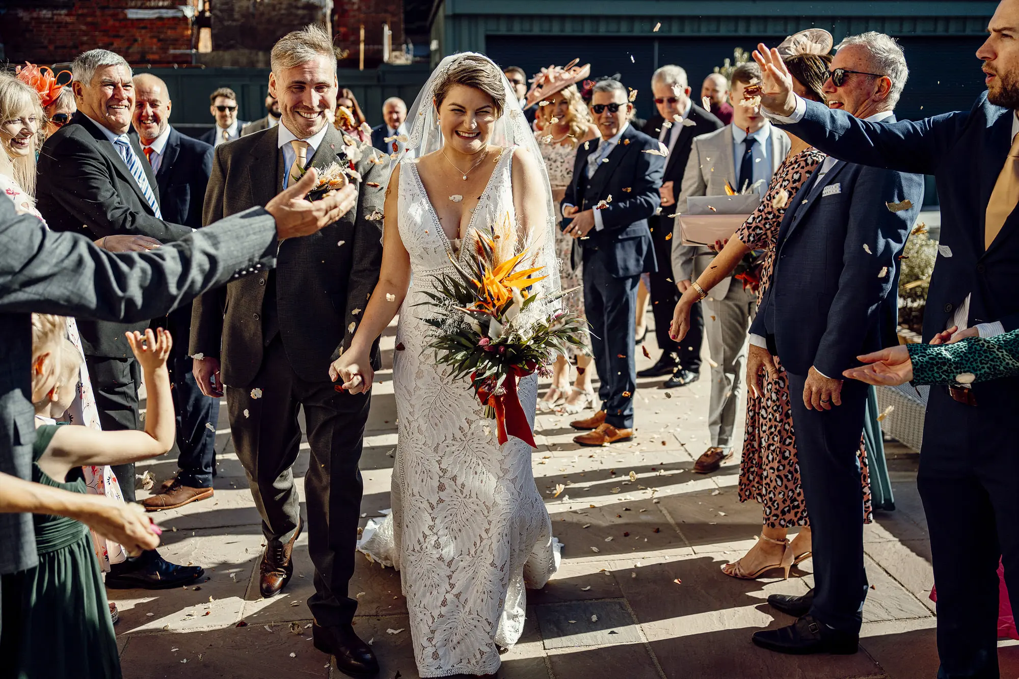 Bride Wearing Boho Lace Wedding Dress Called Burke By Maggie Sottero Leaving Wedding With Confetti Send Off