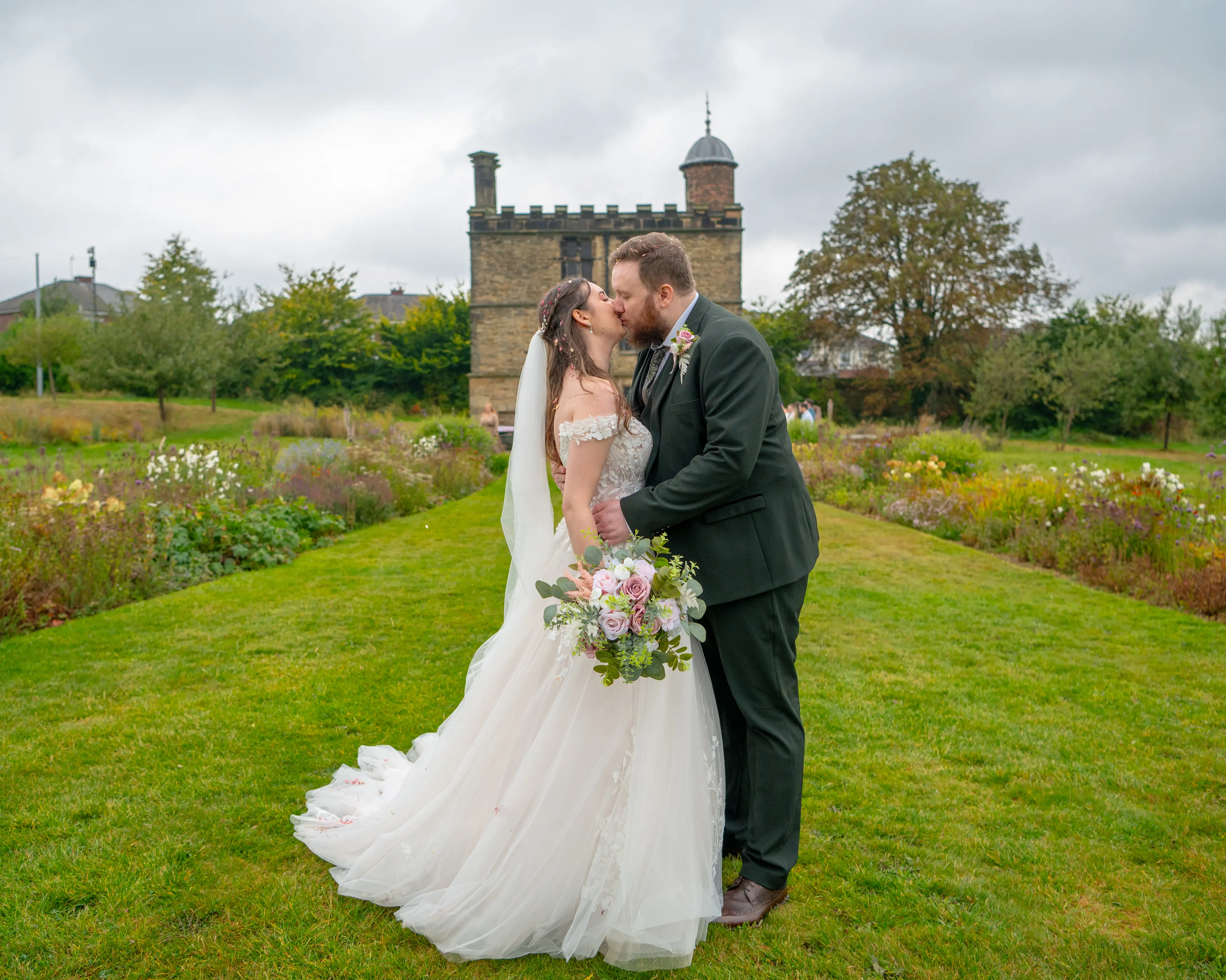 Bride wearing Harlem by Maggie Sottero kissing her husband