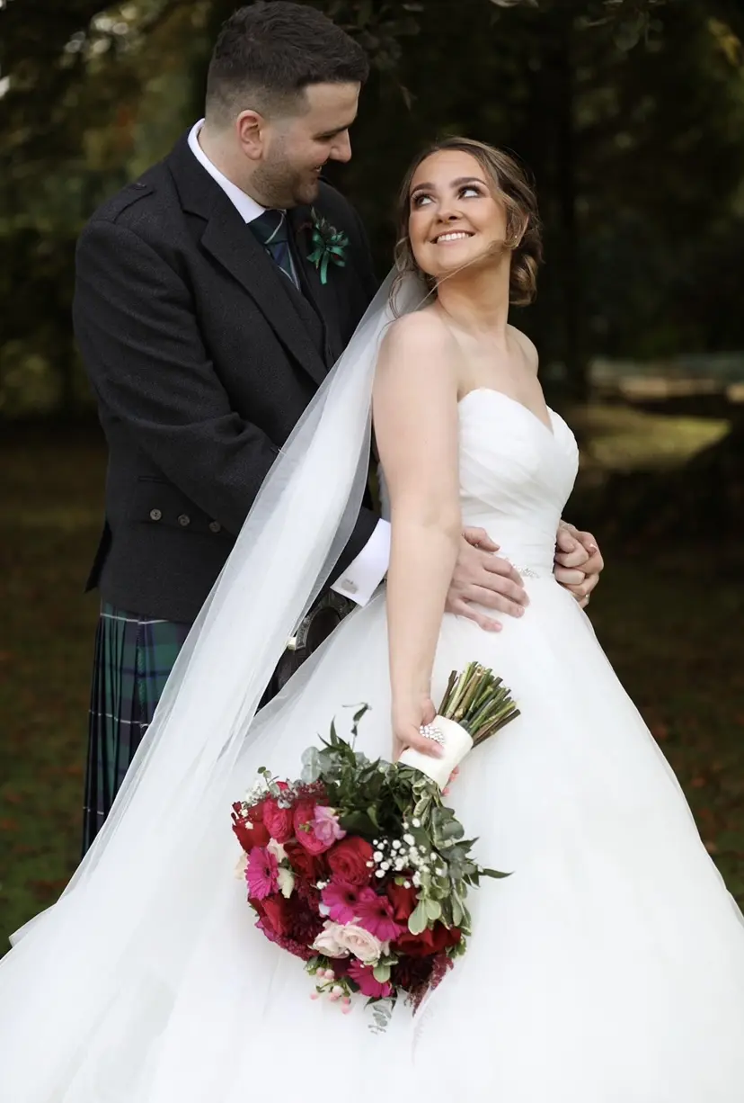 Groom With Bride Wearing Ball Gown With Tiered Skirt Yasmin By Maggie Sottero