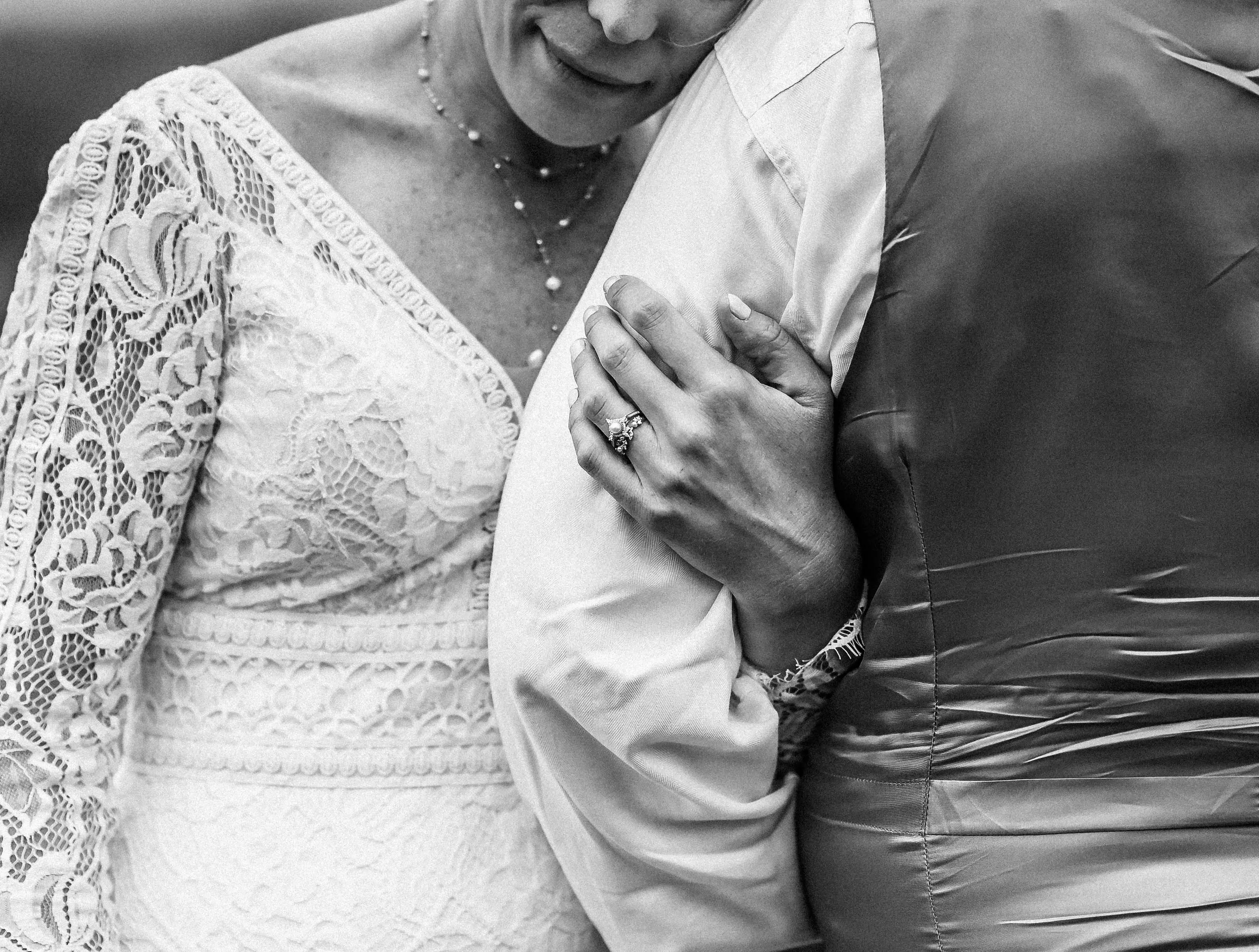 Bride wearing Drita wedding dress by Maggie Sottero hugging her husband