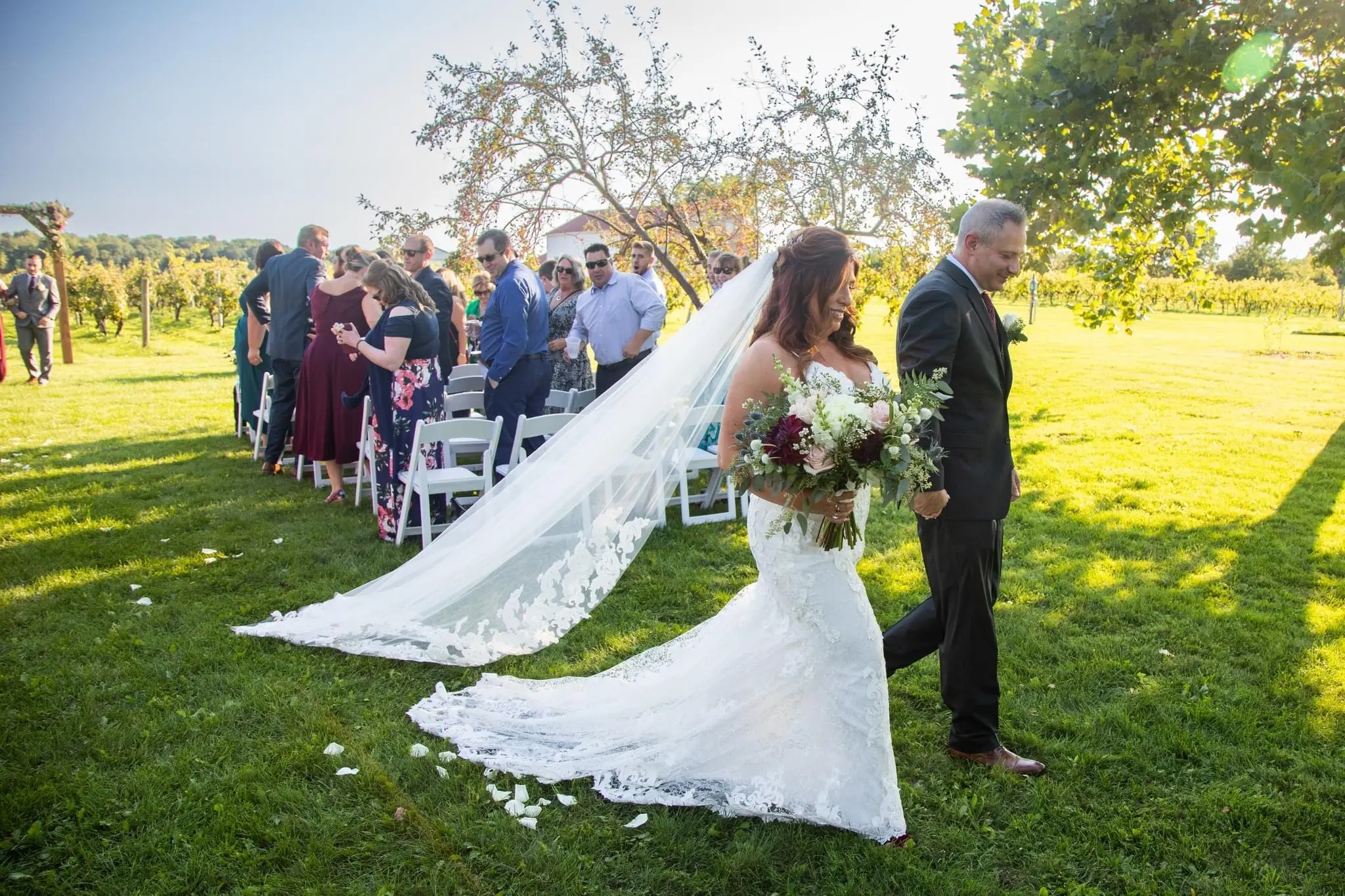 Bride Wearing Sexy Mermaid Wedding Dress Called Tuscany By Maggie Sottero Walking Down The Aisle With Long Veil