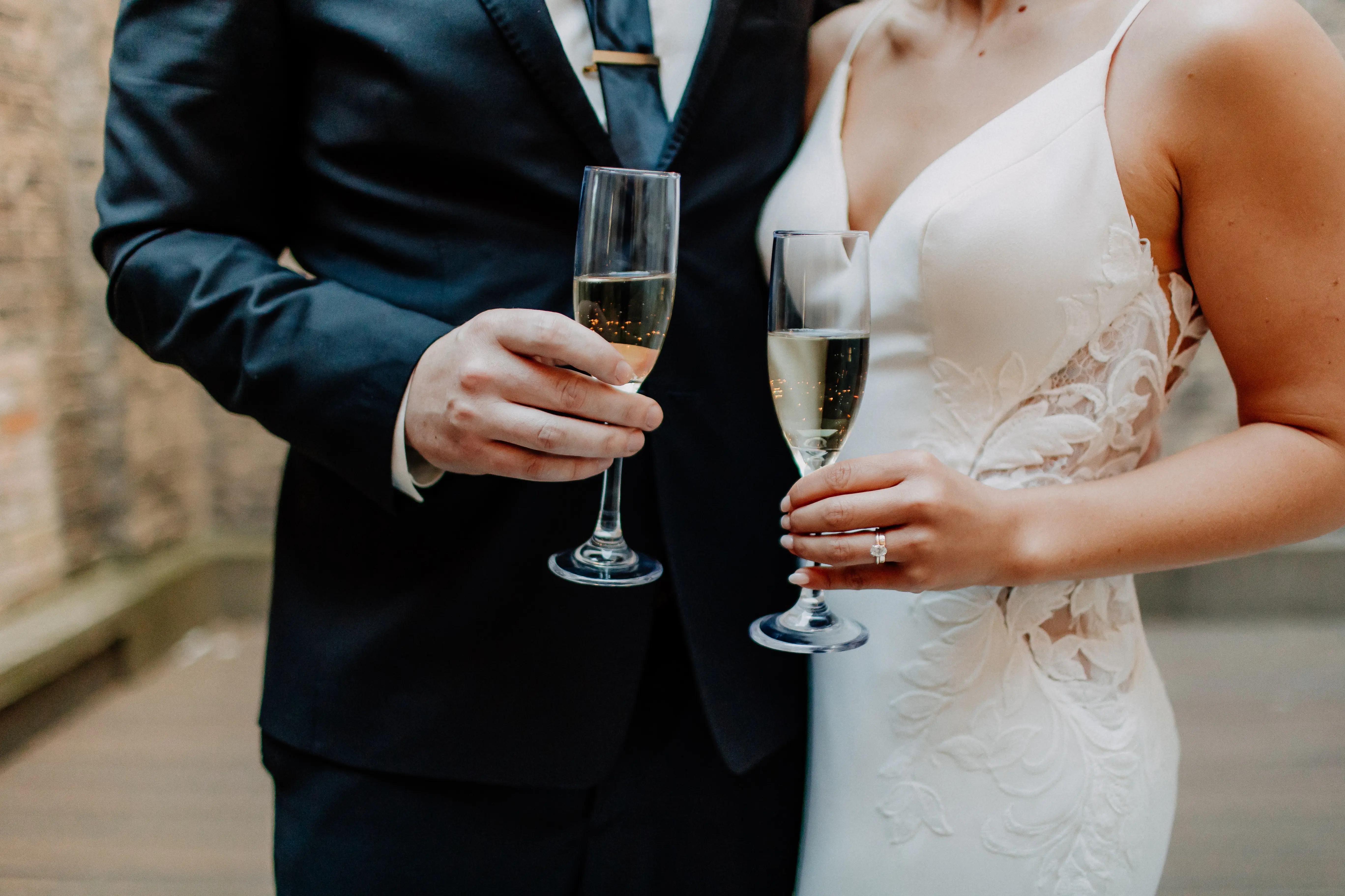 Bride wearing Dionne by Rebecca Ingram drinking with her husband