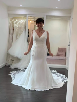 Bride in wedding dress called Adrianna in bridal boutique.