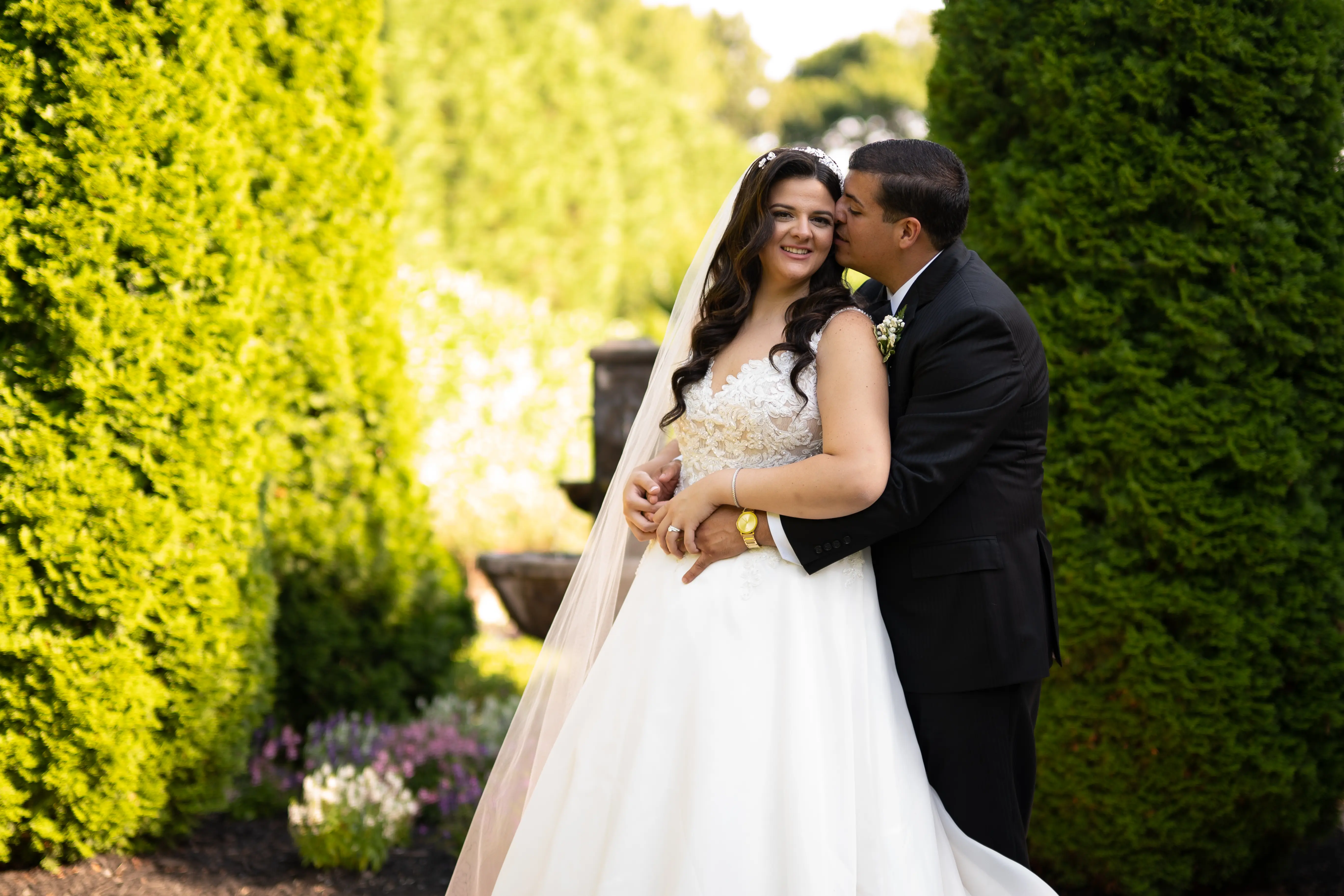 Bride In A-line Wedding Dress Named Savannah By Maggie Sottero Groom Kissing Brides Cheek