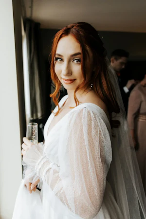 Bride Wearing Sexy Long Sleeve A-Line Wedding Dress Indoors.