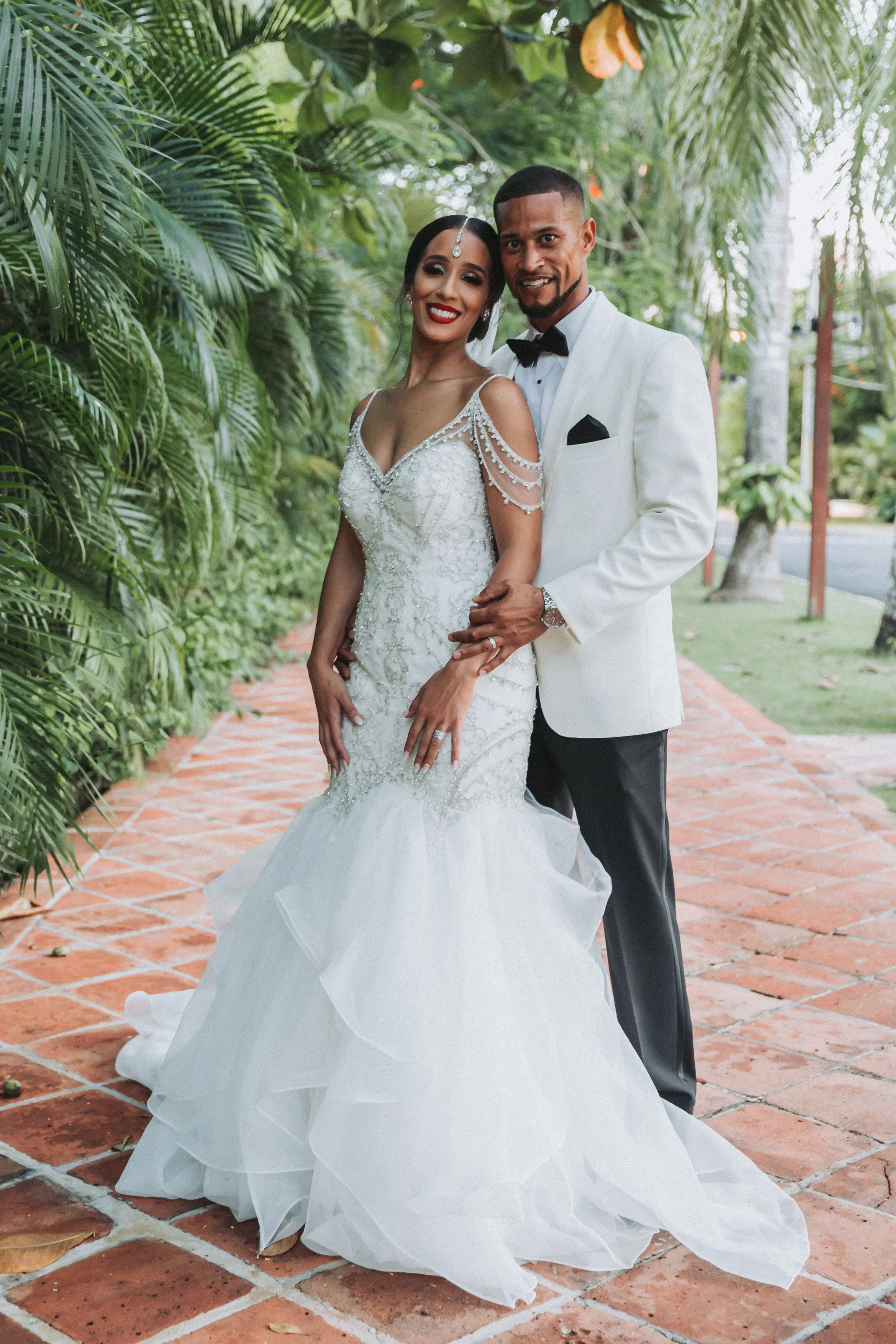 Bride with groom wearing glamorous mermaid wedding dress