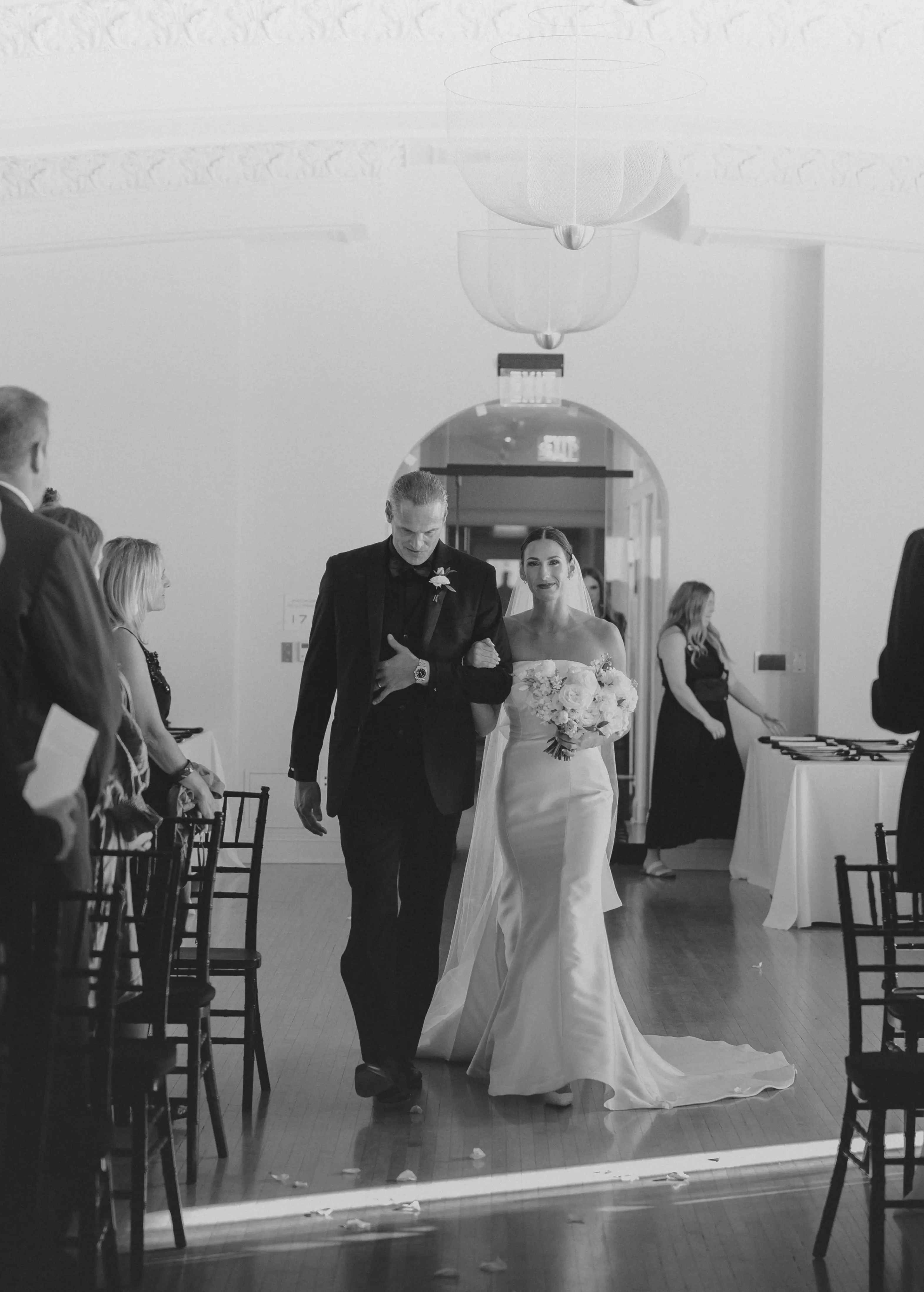 Bride wearing Mitchell wedding dress by Maggie Sottero walking down the aisle