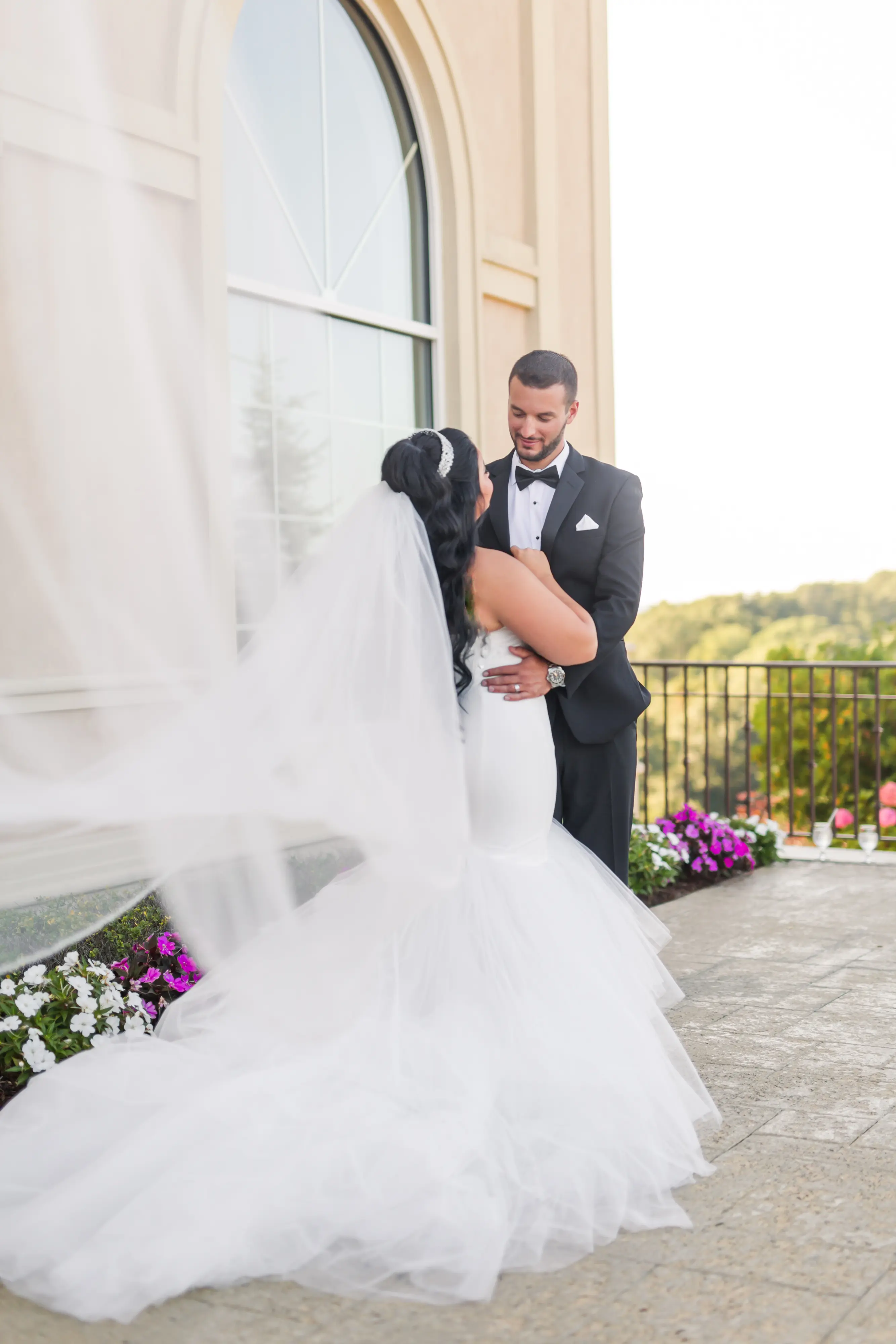 Bride Wearing Simple Mermaid Wedding Dress Called Holden By Sottero And Midgley With Groom And Veil Trailing Behind Her