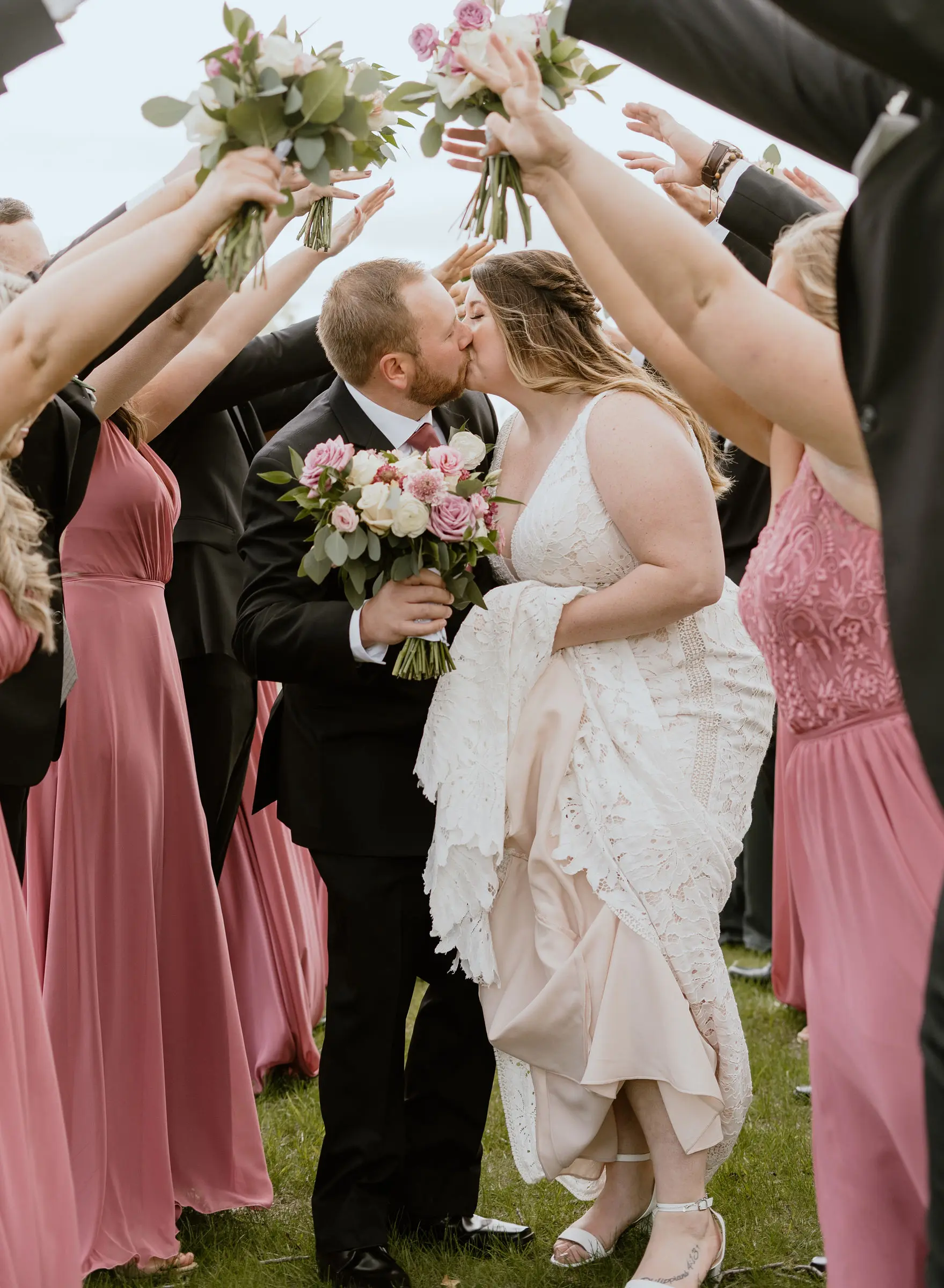 Groom Kissing Bride in Boho Lace Wedding Dress with Oversized Florals Called Burke by Maggie Sottero