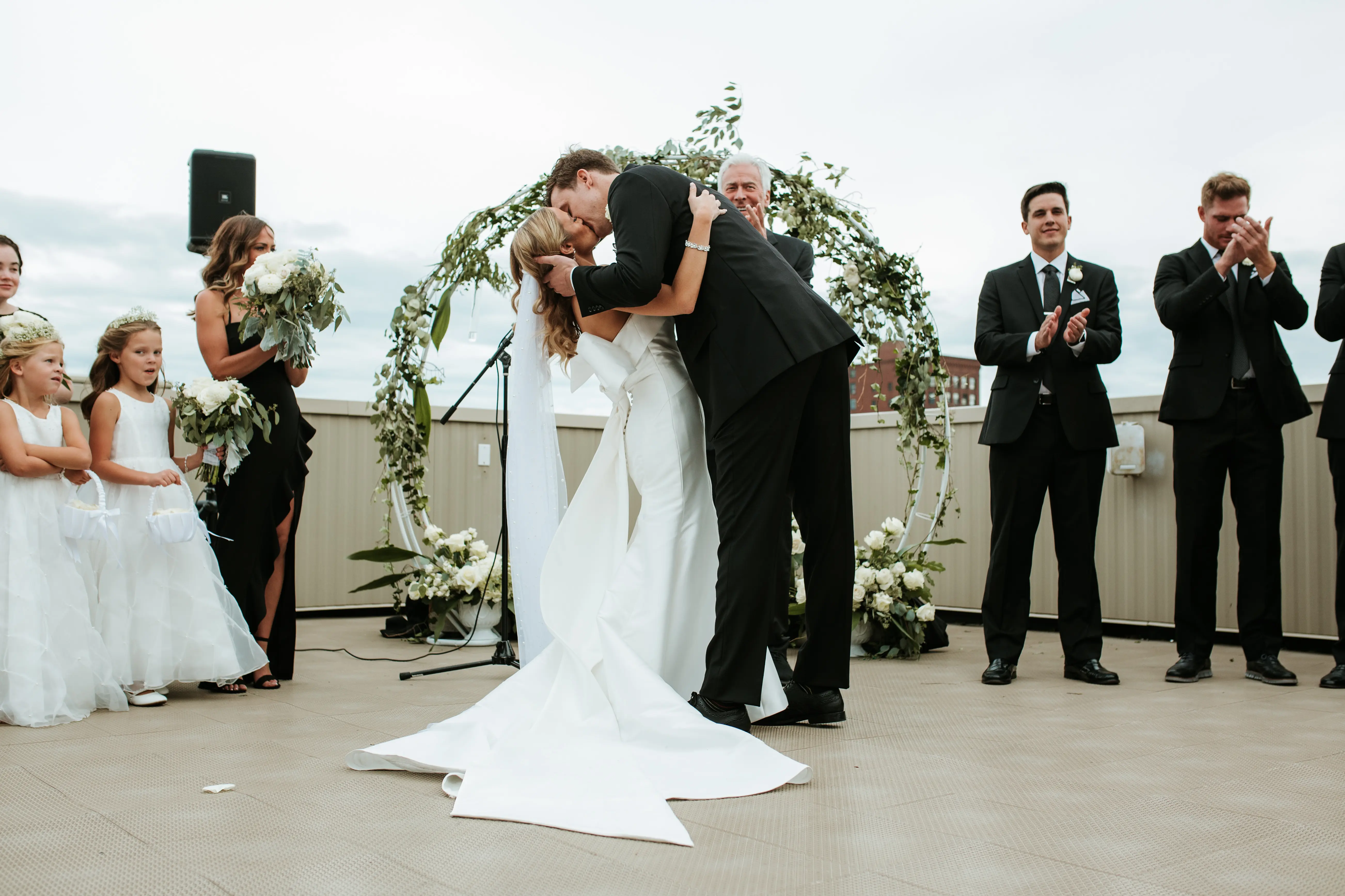 Bride with groom wearing unique strapless wedding dress