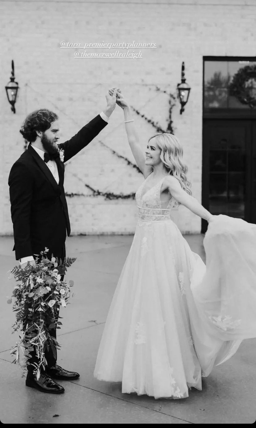 Groom Dancing With Bride Wearing Plunging Lace Illusion Wedding Dress Called Raelynn By Rebecca Ingram