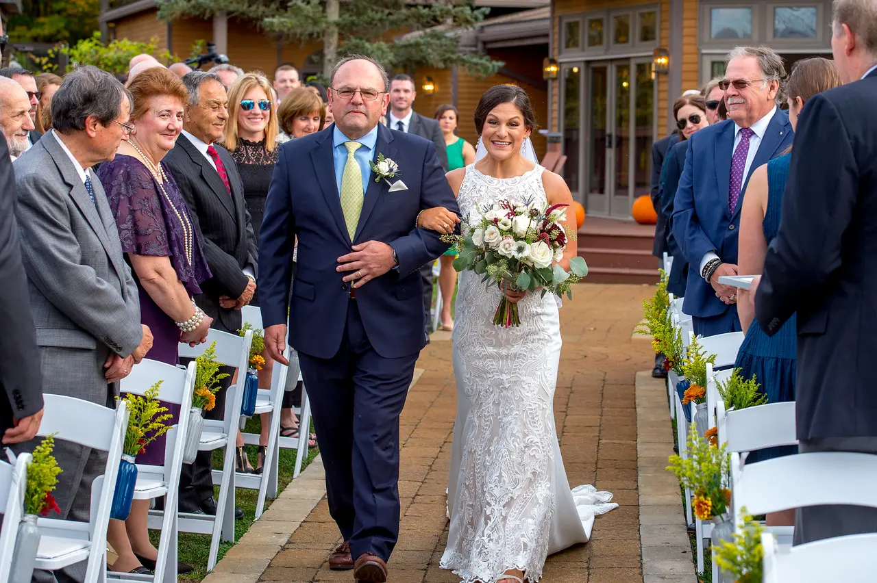 Bride wearing Lace Sheath Wedding Dress called Kevyn by Sottero and Midgley walking down the aisle