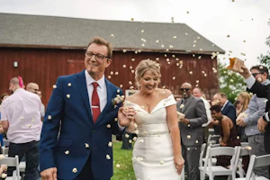 Bride wearing Josie by Rebecca Ingram with her husband getting hit with popcorn