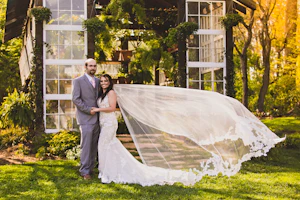 Groom with Bride in Shimmering Lace Motif Wedding Gown with Plunging Sweetheart Neckline Called Tuscany Lynette by Maggie Sottero