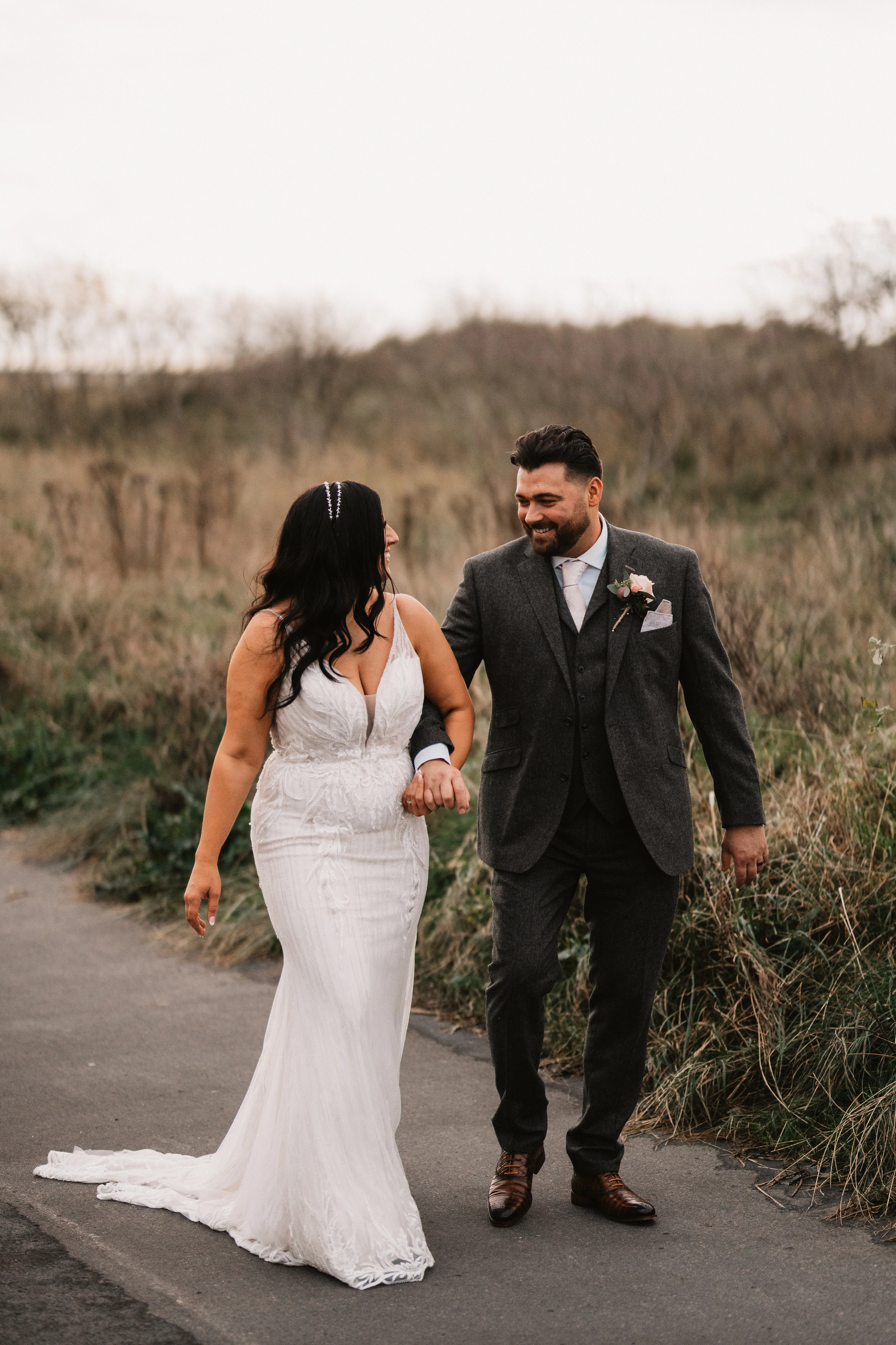 Bride Wearing Art Deco Wedding Dress Called Luella By Sottero And Midgley Holding Hands And Walking With Groom