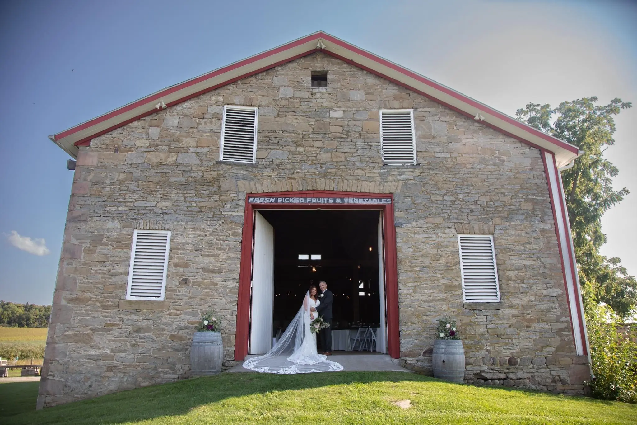 Bride Wearing Sexy Mermaid Wedding Dress Called Tuscany By Maggie Sottero With Groom In Open Barn Door