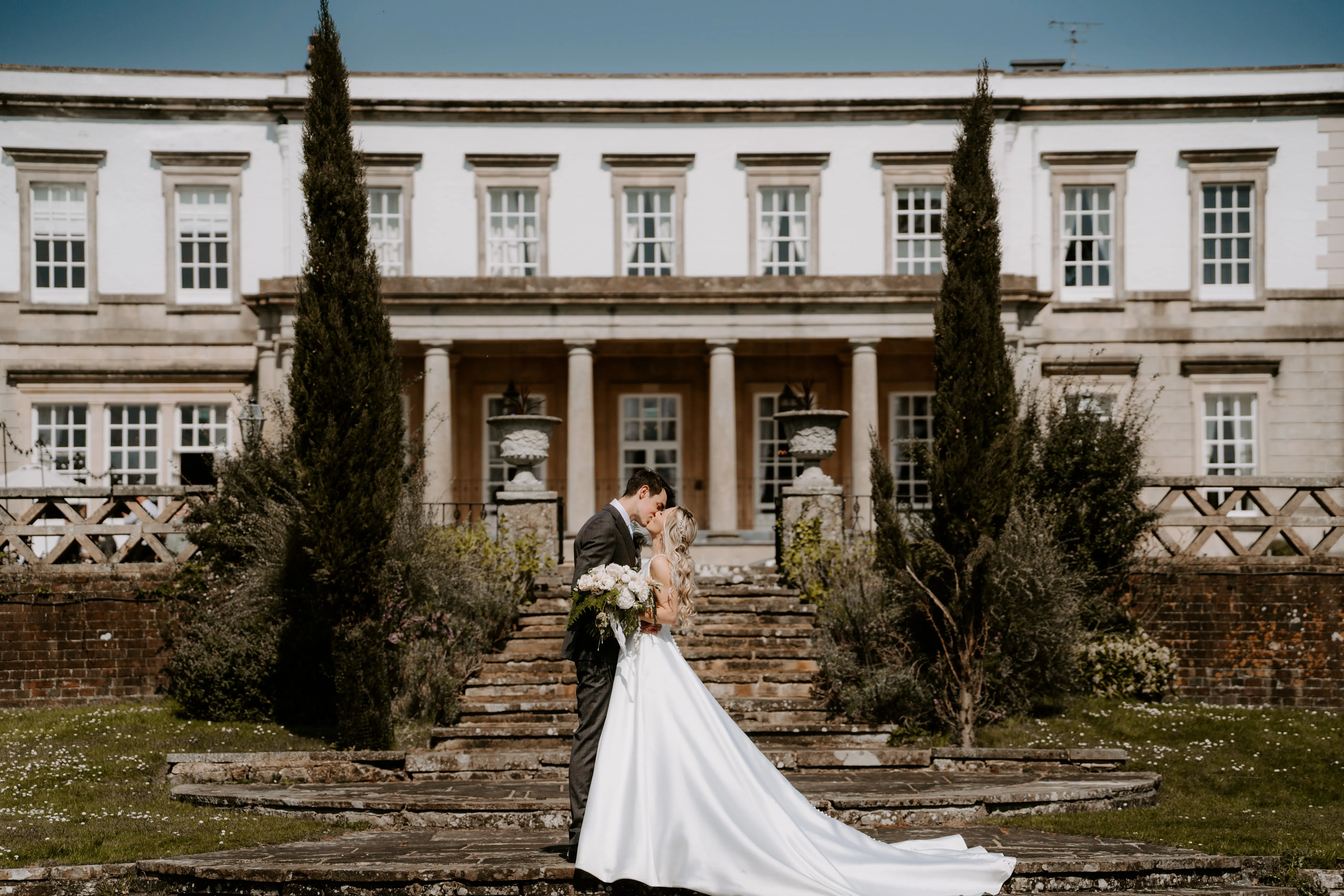 Groom With Bride Wearing Mikado A-Line Wedding Dress Raven By Maggie Sottero