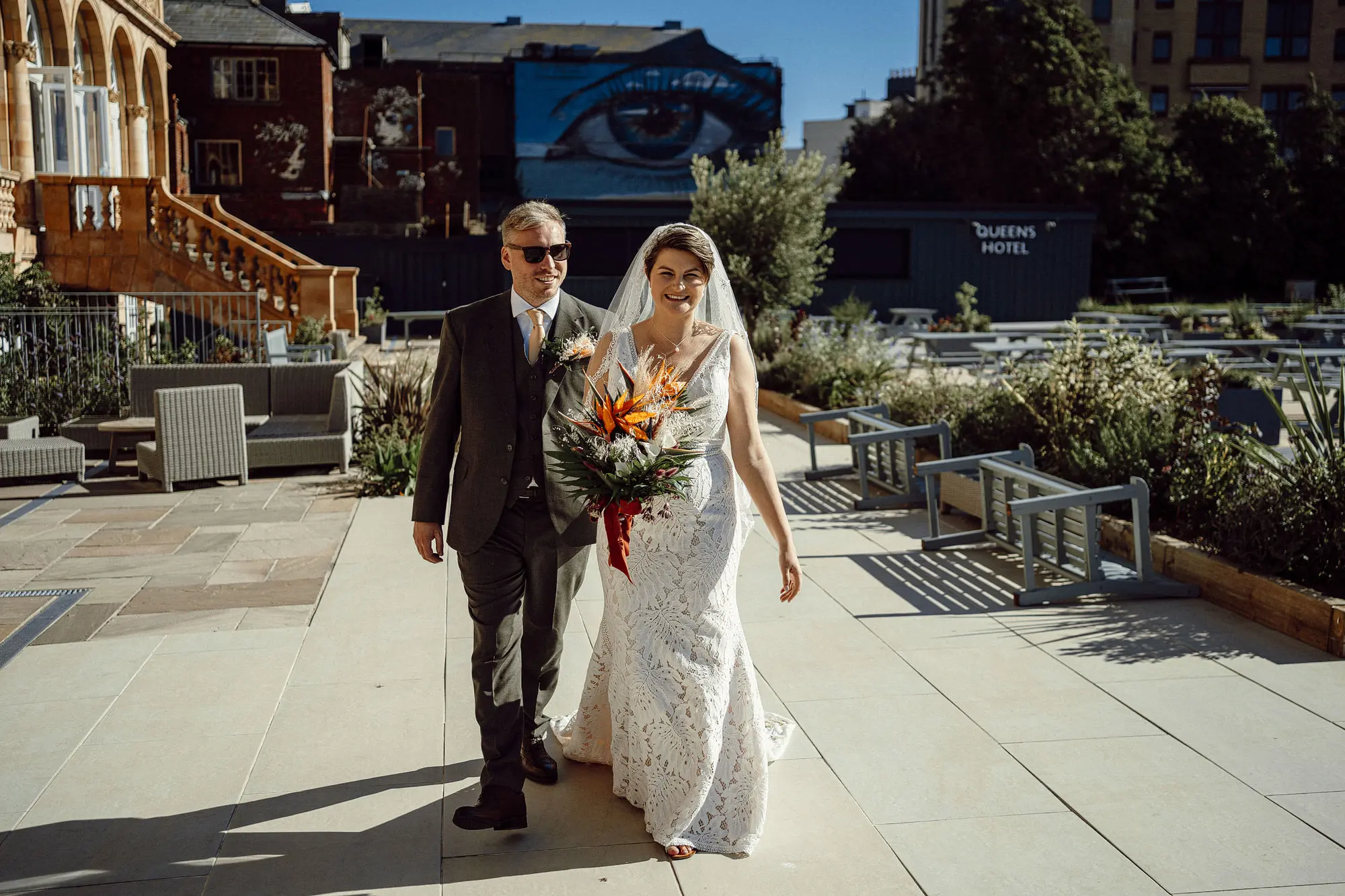 Bride Wearing Boho Lace Wedding Dress Called Burke By Maggie Sottero Walking Down The Street With Groom