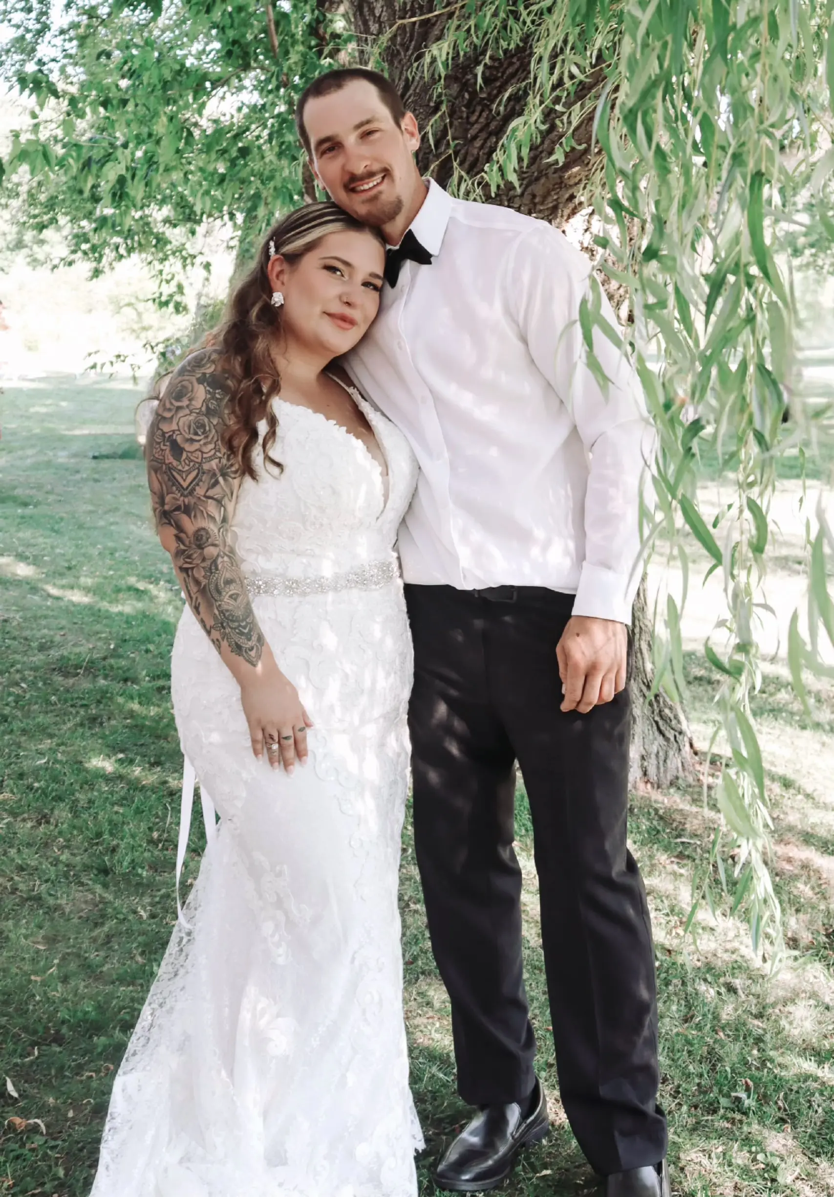 Bride Wearing Sheath Lace Wedding Dress With Beaded Belt Called Tuscany Lynette By Maggie Sottero Under A Tree