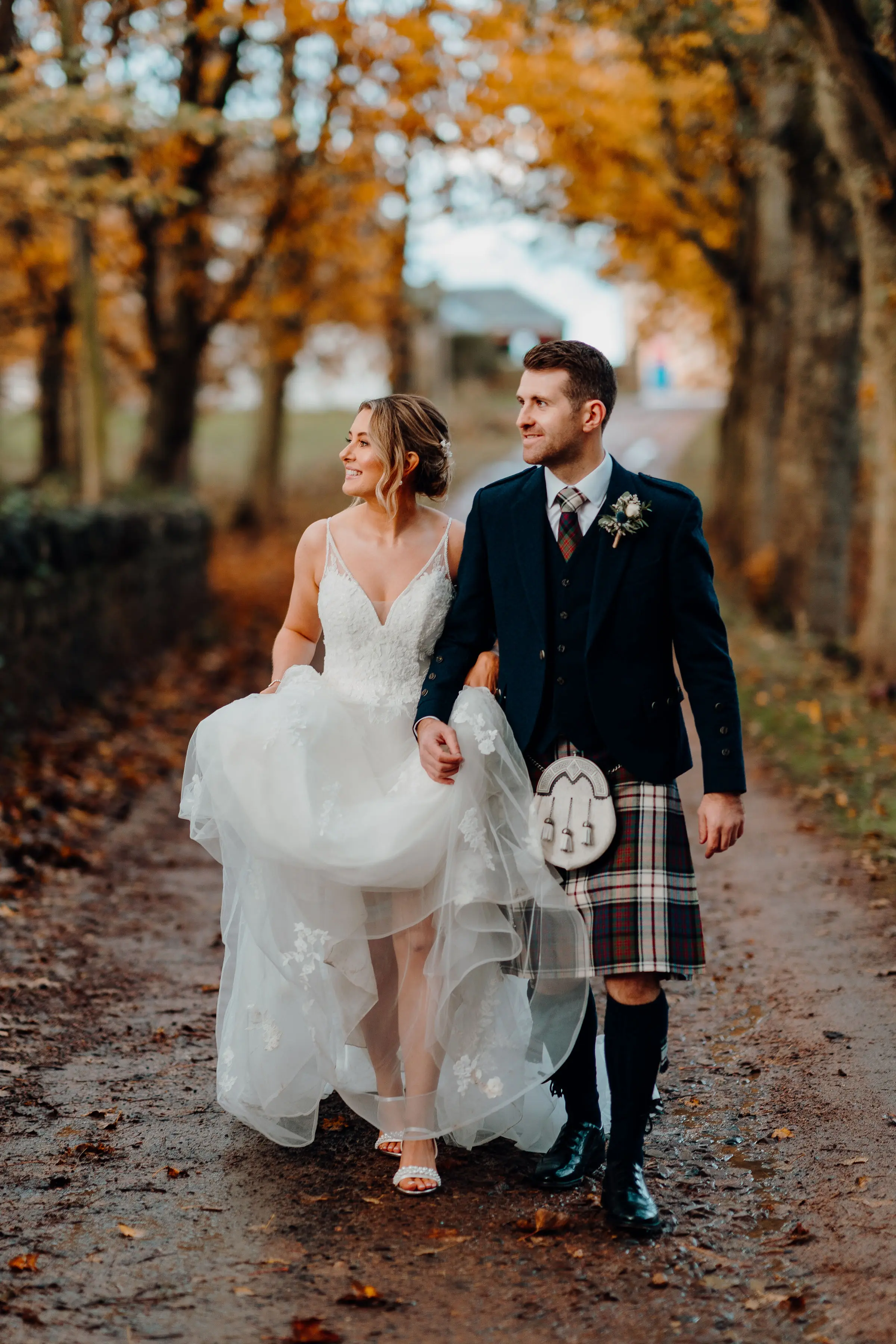 Bride wearing Lettie wedding dress by Rebecca Ingram walking with her husband