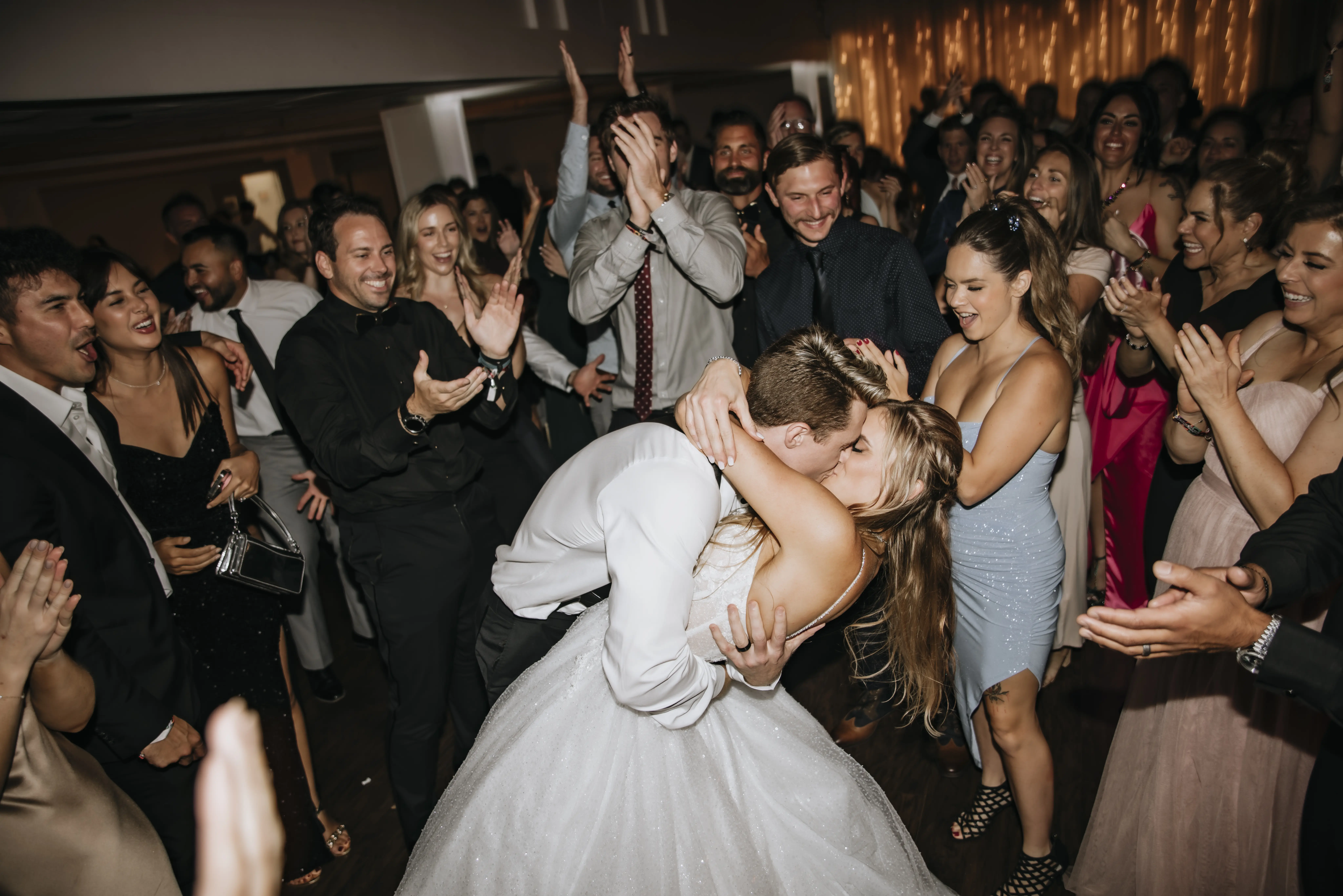Bride Wearing Sparkly Ballgown Wedding Dress Called Shasta By Sottero And Midgley Kissing Groom At The Reception