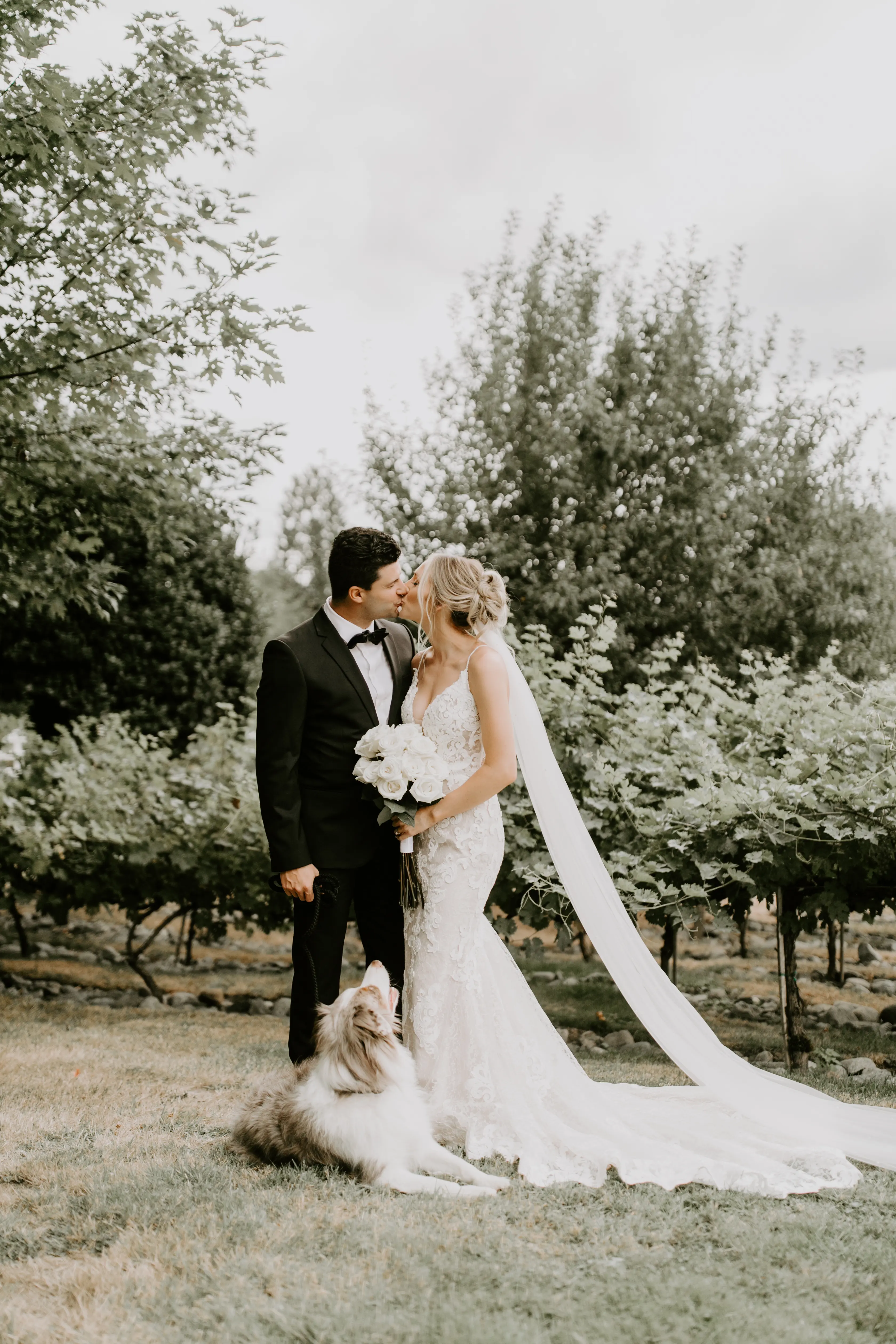 Bride with groom wearing romantic lace sheath wedding dress