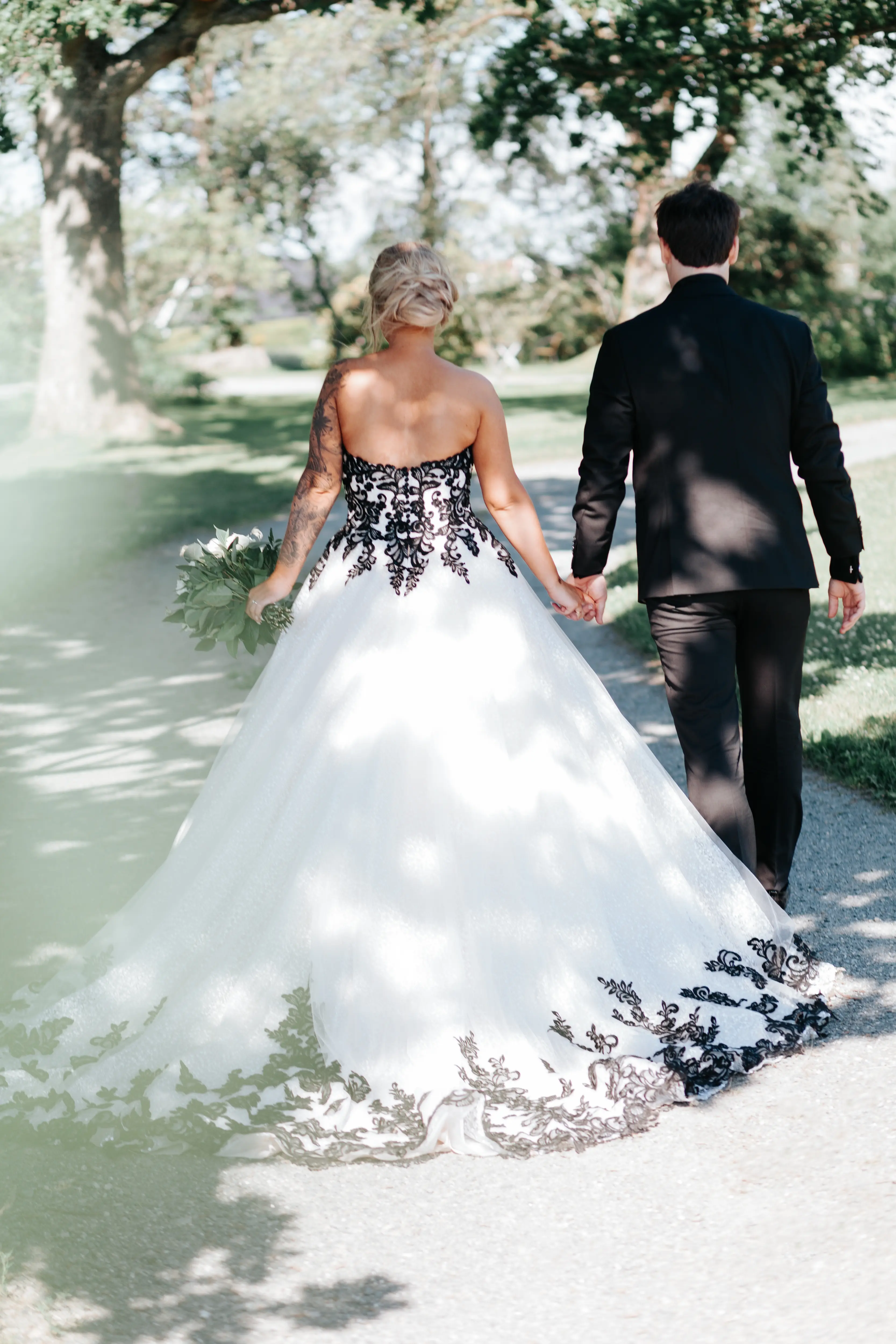 Groom With Bride Wearing Ballgown With Black Lace Detail Called Tristyn By Maggie Sottero
