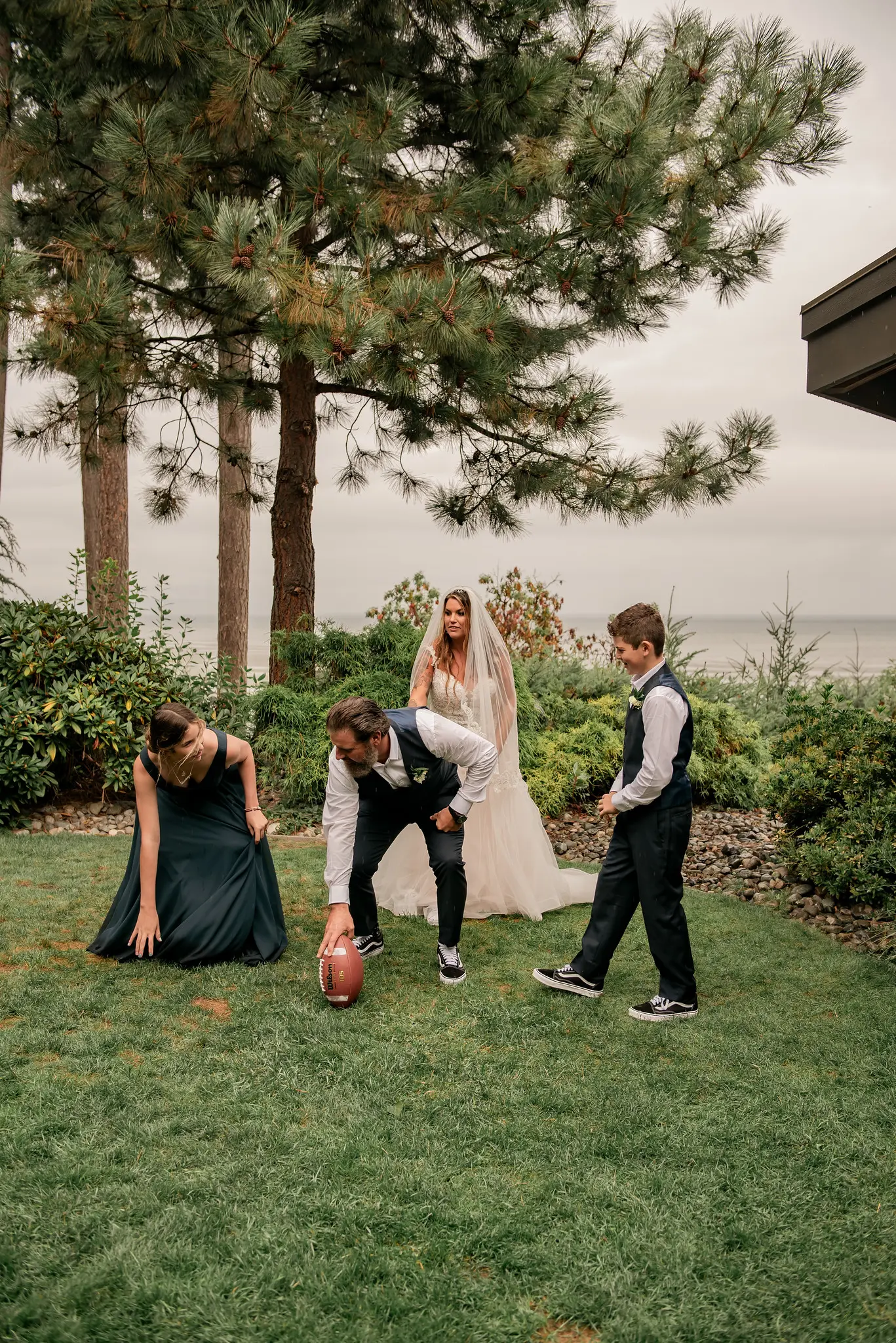 Bride wearing Boho Wedding Dress called Stevie by Maggie Sottero playing football with groom and bridal party