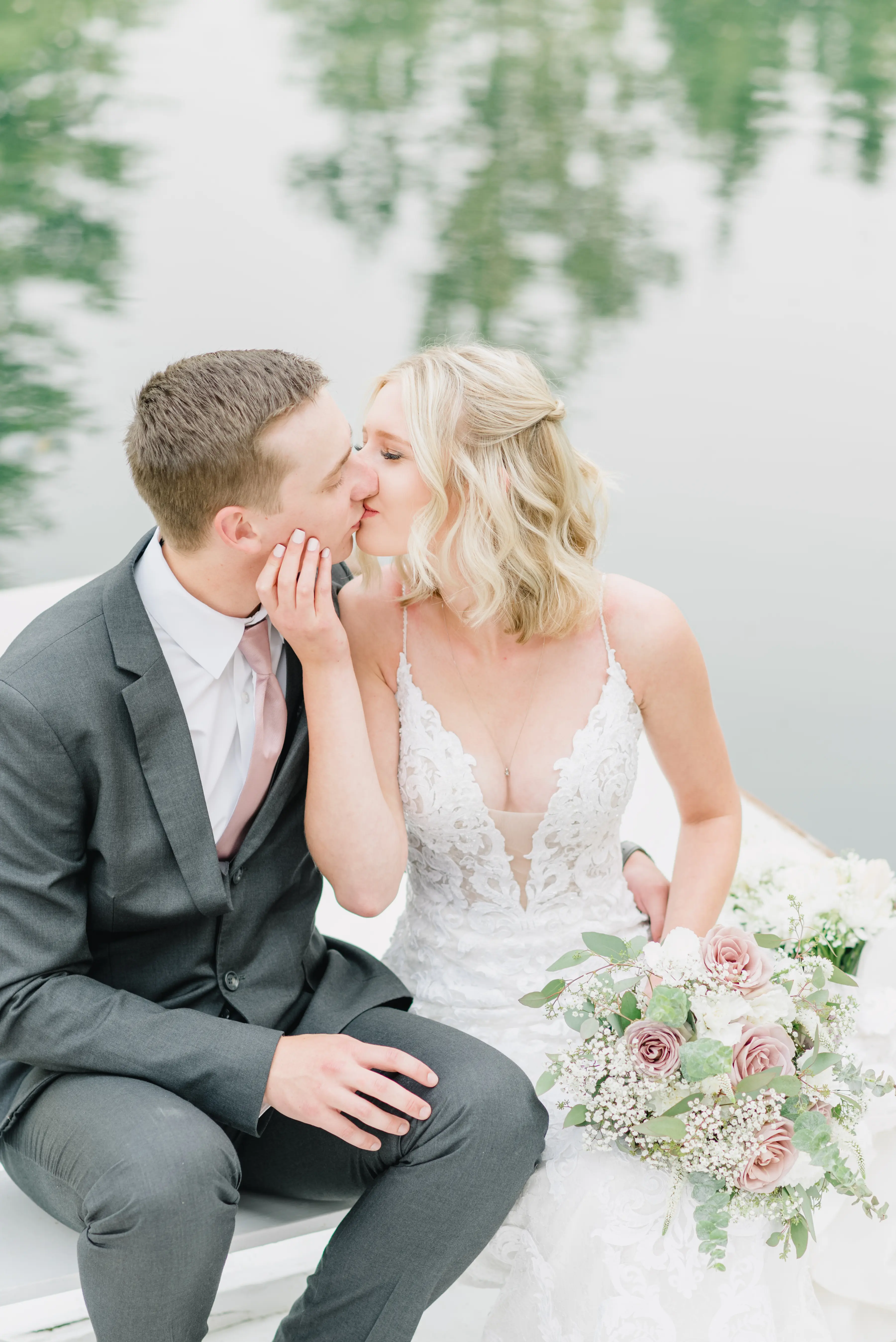 Bride with groom wearing lace sheath wedding dress