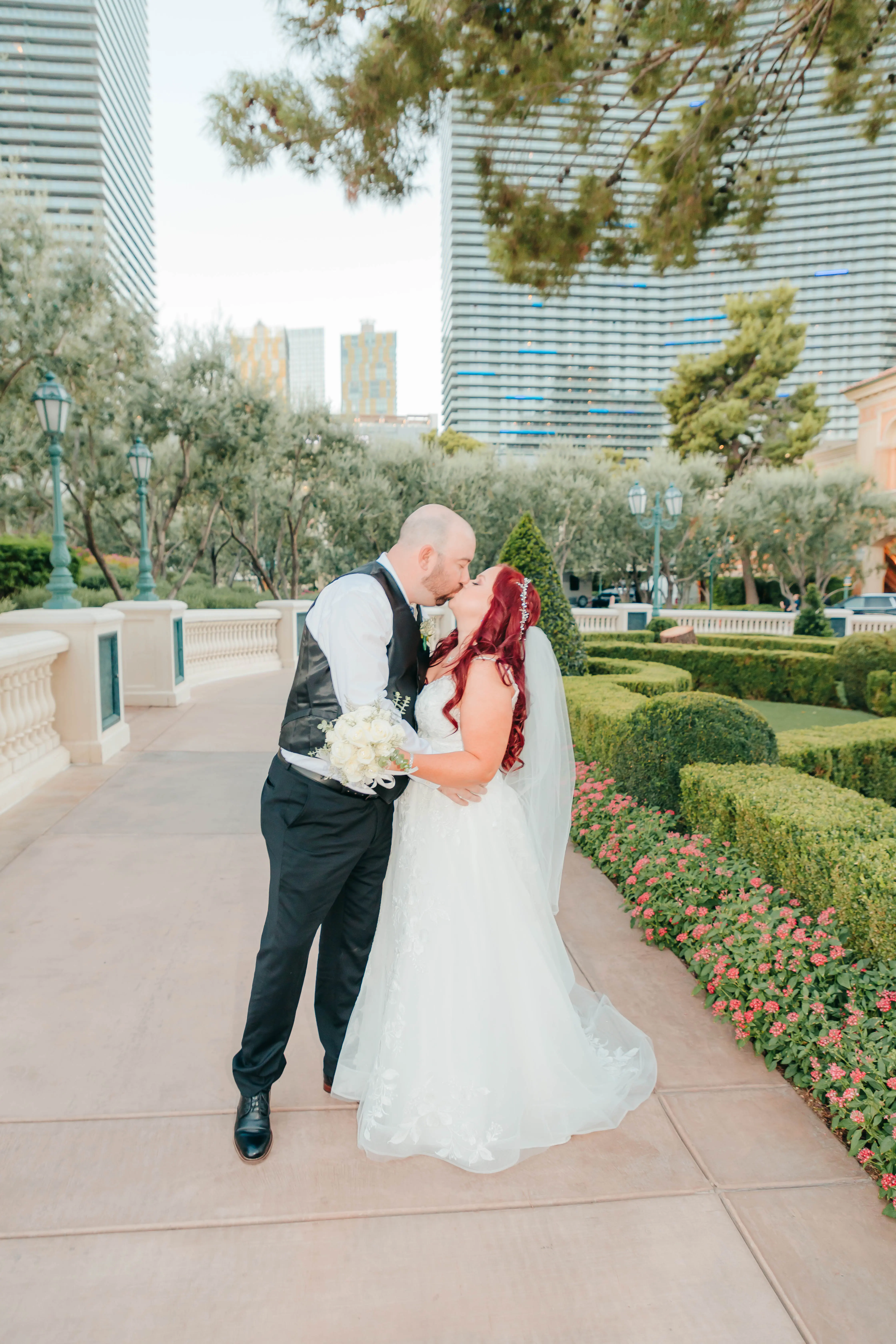 Groom and Bride Kissing at a Las Vegas Wedding Wearing Lace Ballgown Called Ellen by Rebecca Ingram