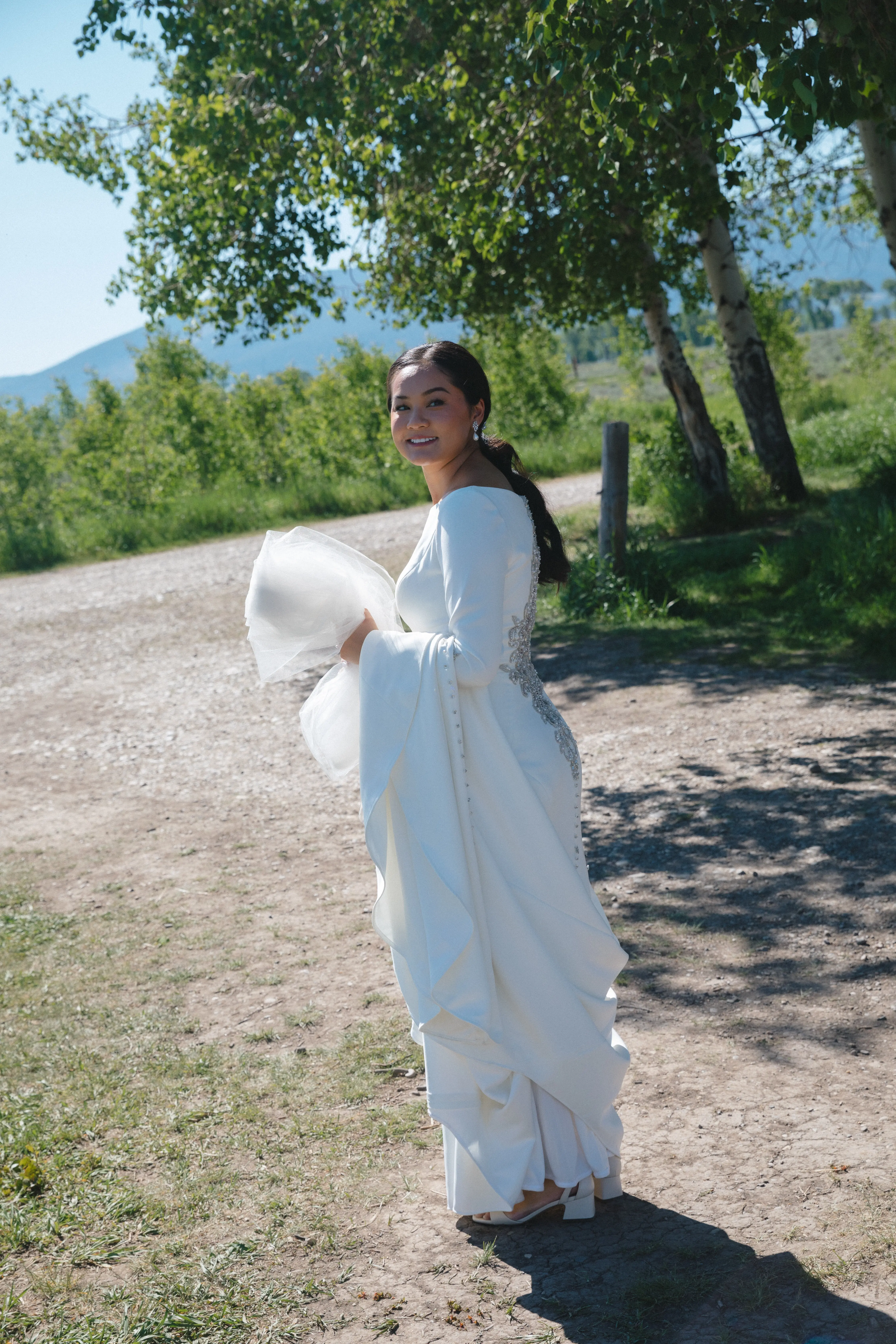 Bride wearing Aston by Sottero and Midgley carrying her dress