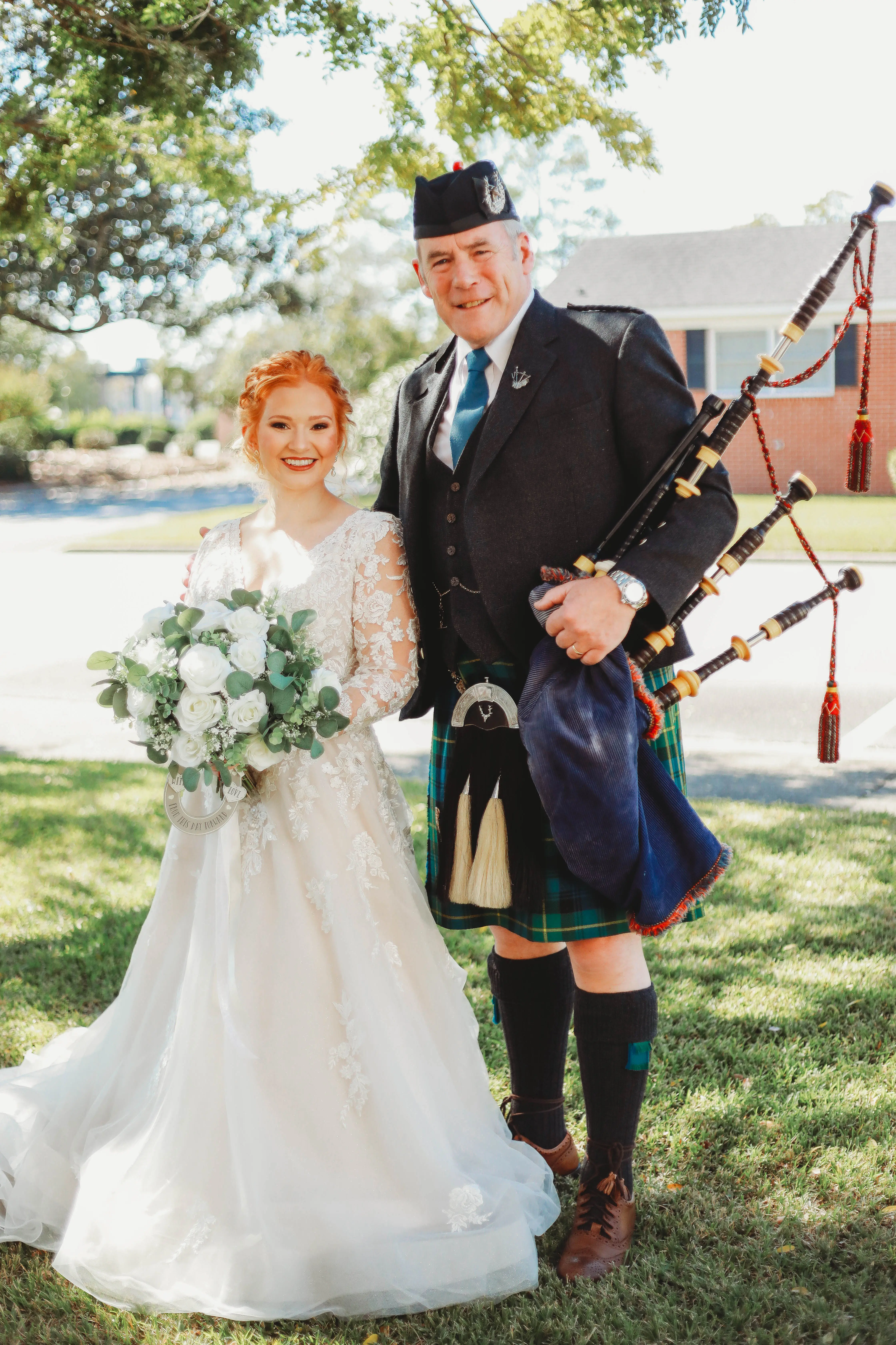 Bride Standing With Bagpipe Artist. Bride Wearing A-Line Long Sleeve Dress Called Raphael By Maggie Sottero