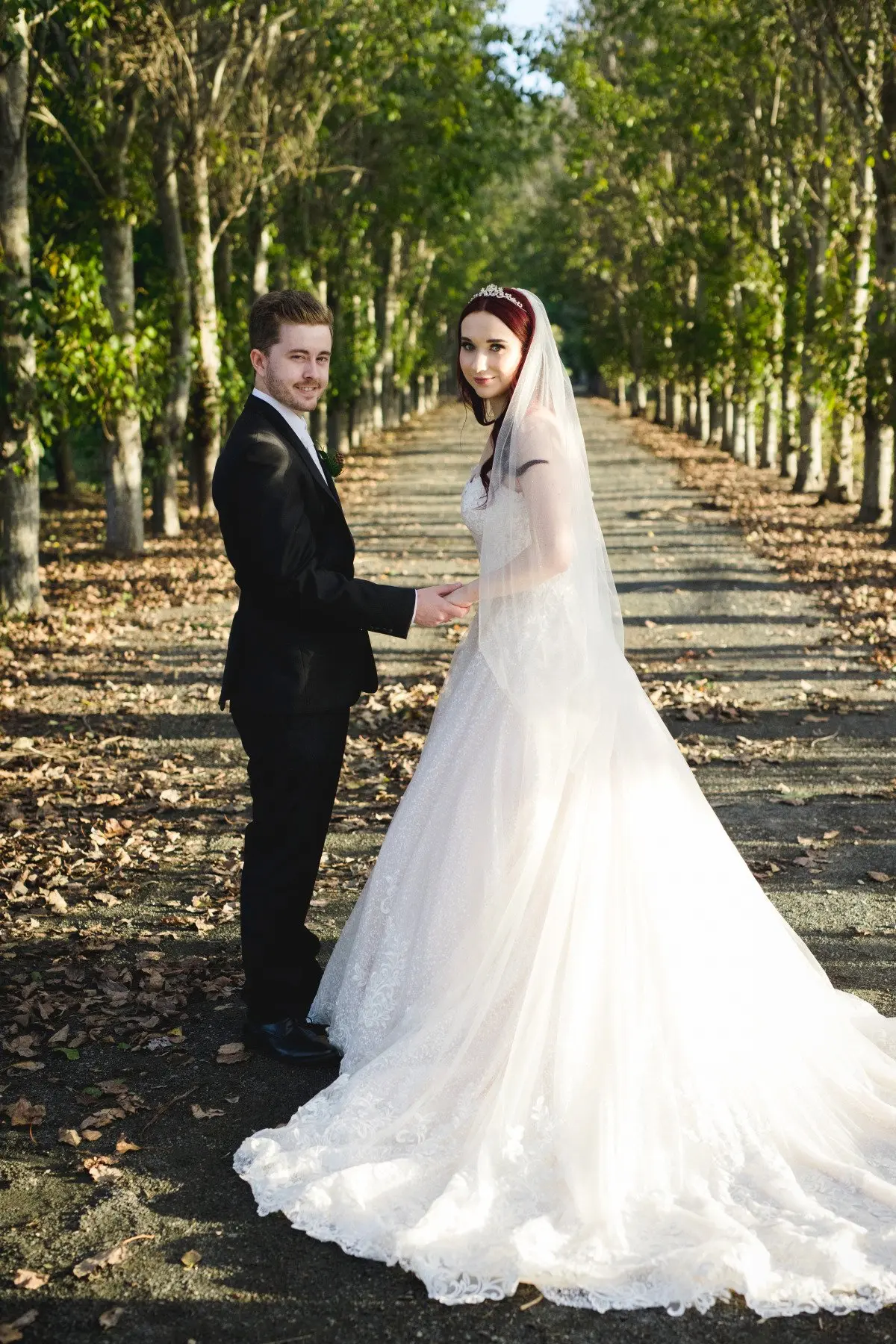 Groom with Bride in Lace Ball Gown Wedding Dress with Sequined Tulle and Lace Motifs over Bodice and Statement Hemline called Tristyn by Maggie Sottero