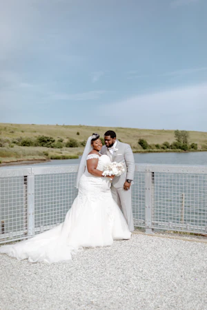Groom looking at his bride wearing wedding dress called Alistaire Lynette.