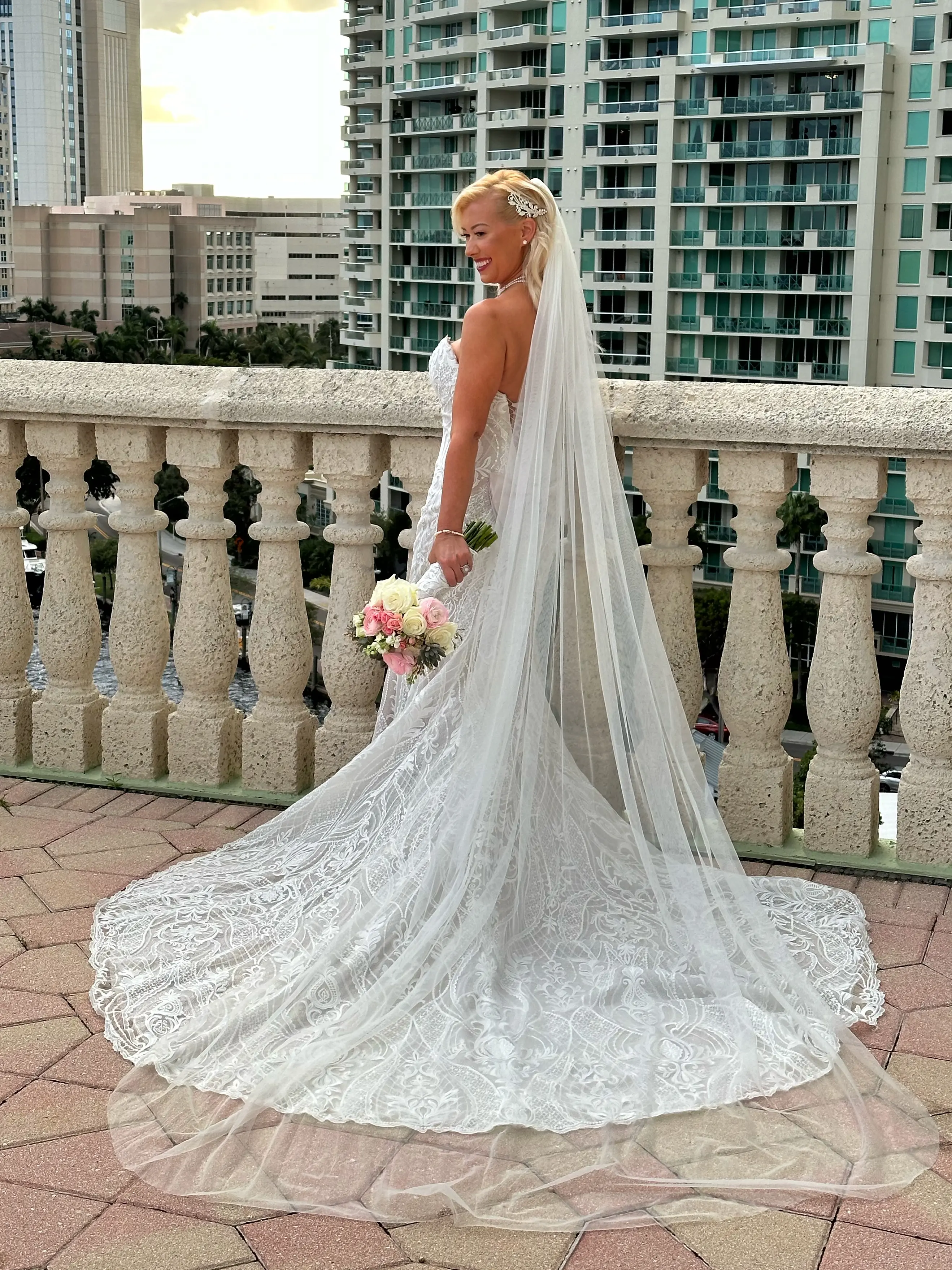Bride Wearing Lace Mermaid Wedding Dress Called Bronson By Sottero And Midgley Holding A Pink And White Bouquet