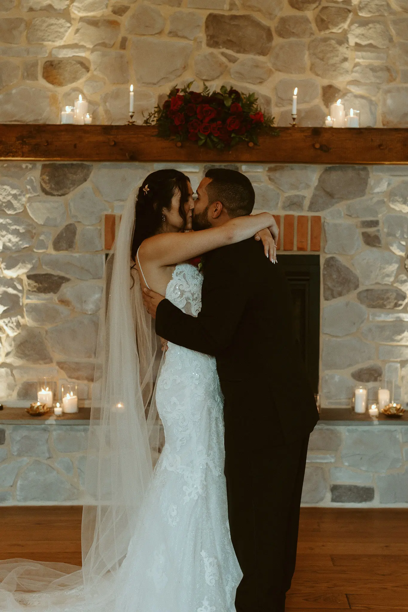 Bride with groom wearing lace sheath wedding dress.