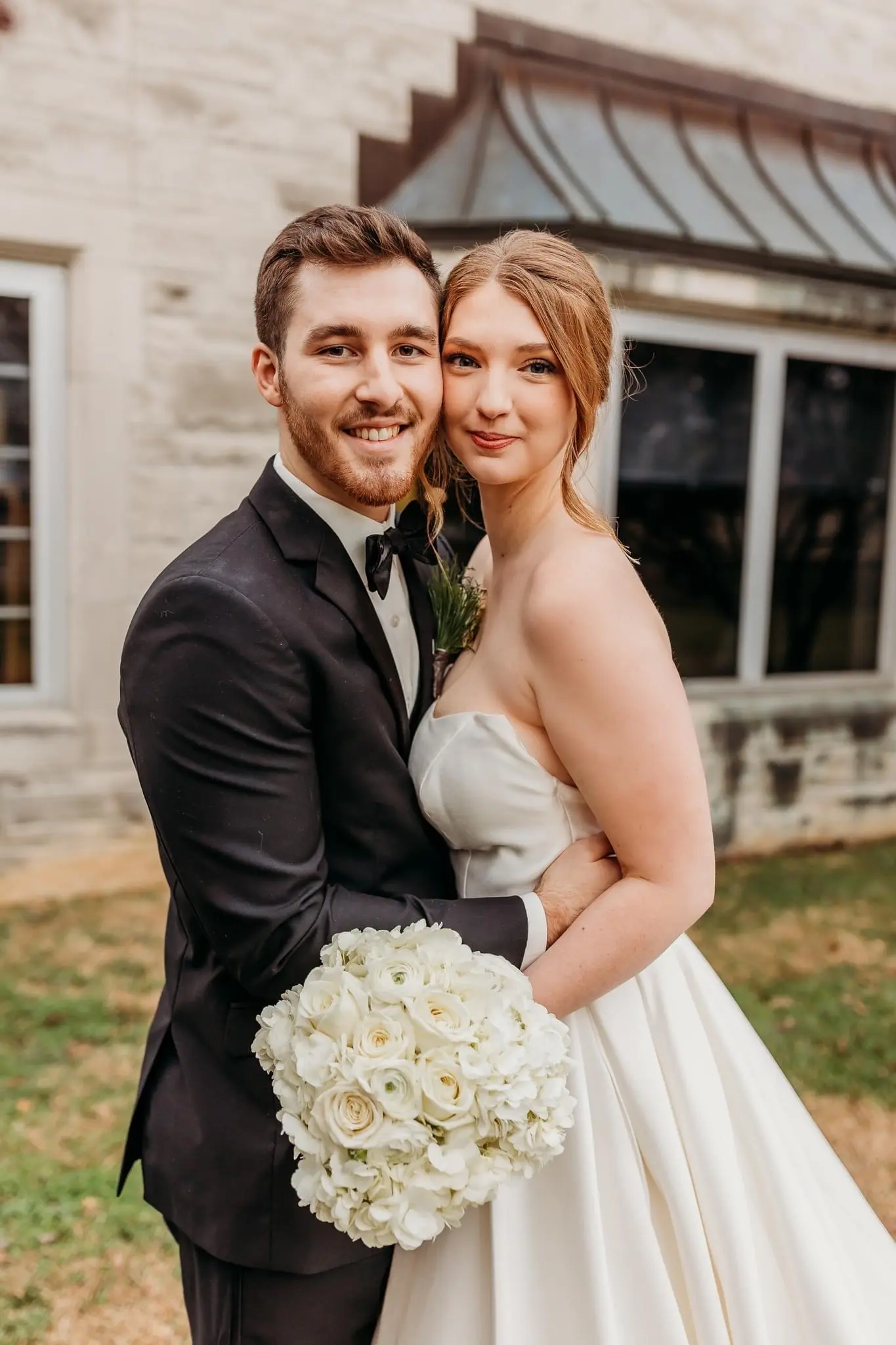 Groom Posing With Bride Wearing A Strapless White Wedding Dress Named Selena By Maggie Sottero