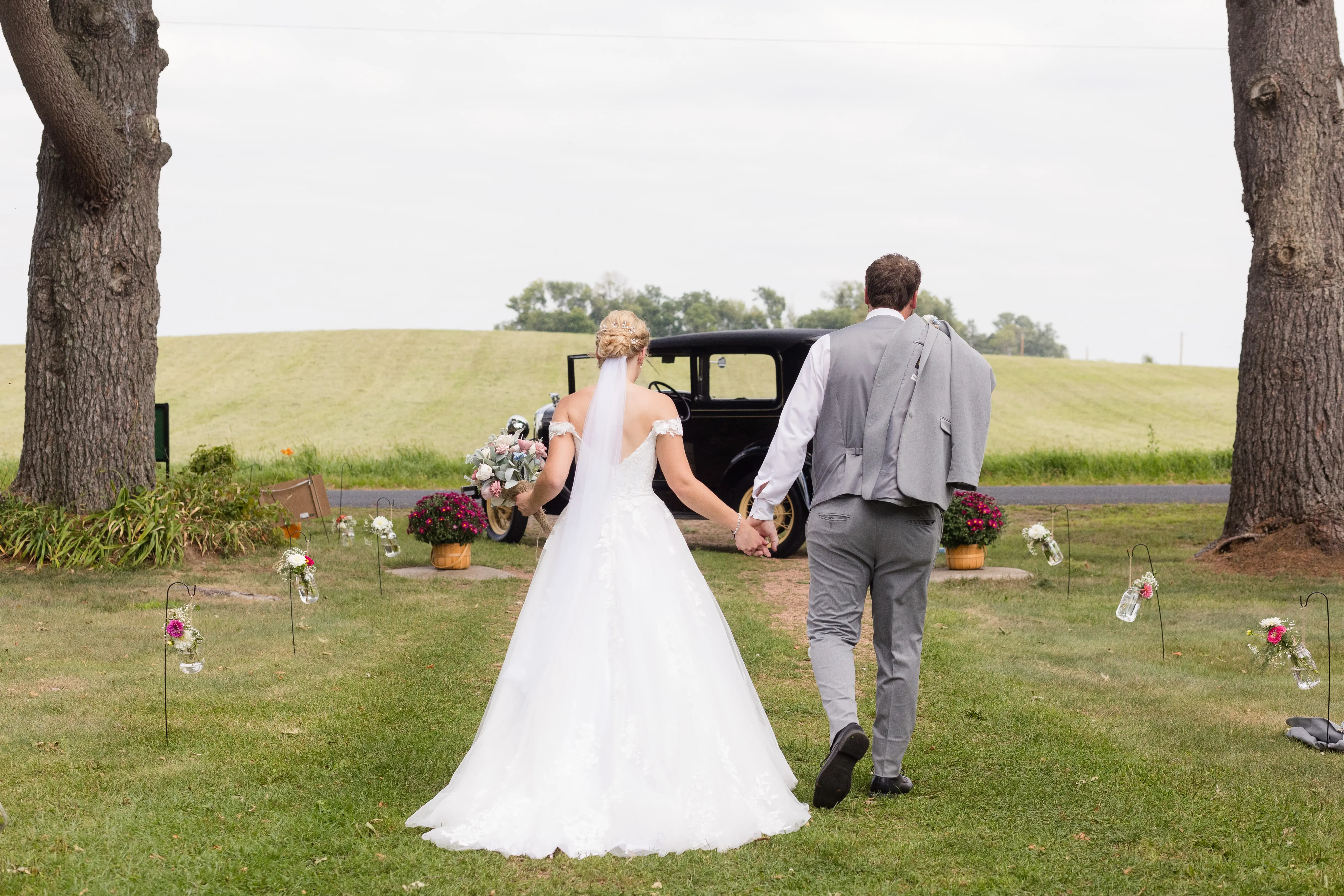 Bride Wearing Ballgown Wedding Dress Called Harlem By Maggie Sottero Holding Hands With Groom