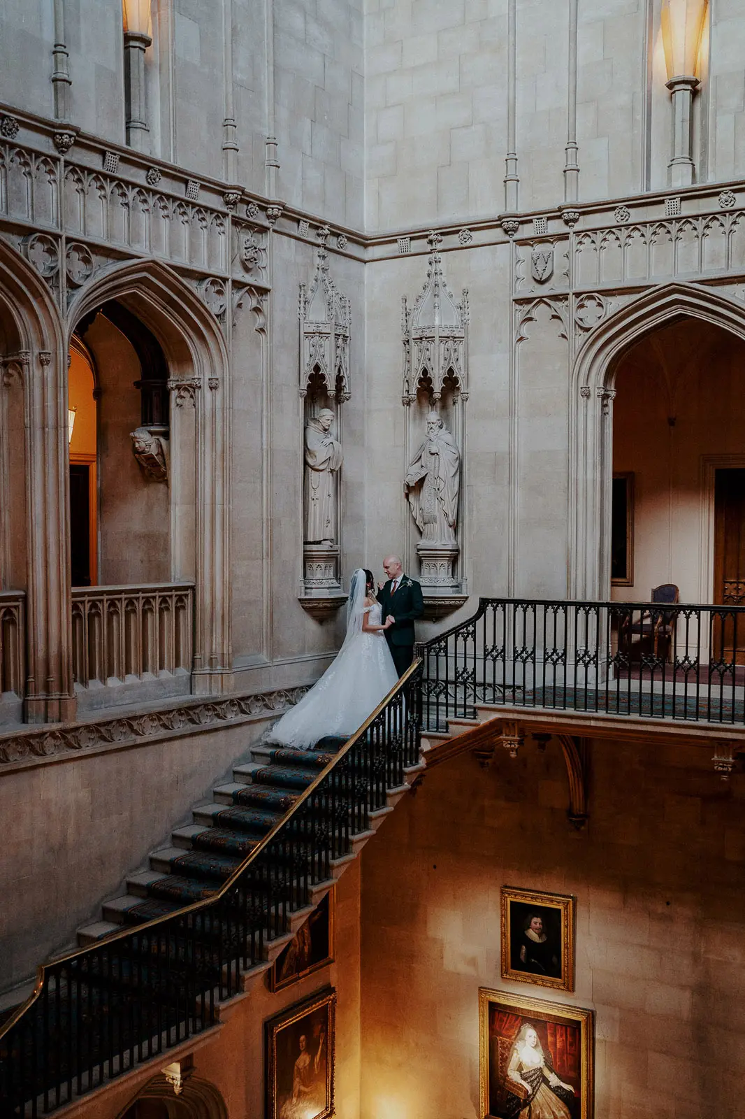 Bride wearing Harlem by Maggie Sottero with her husband on the stairs
