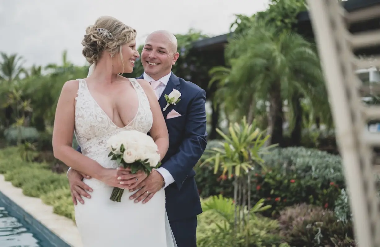 Bride and groom laughing together looking into each others eyes.