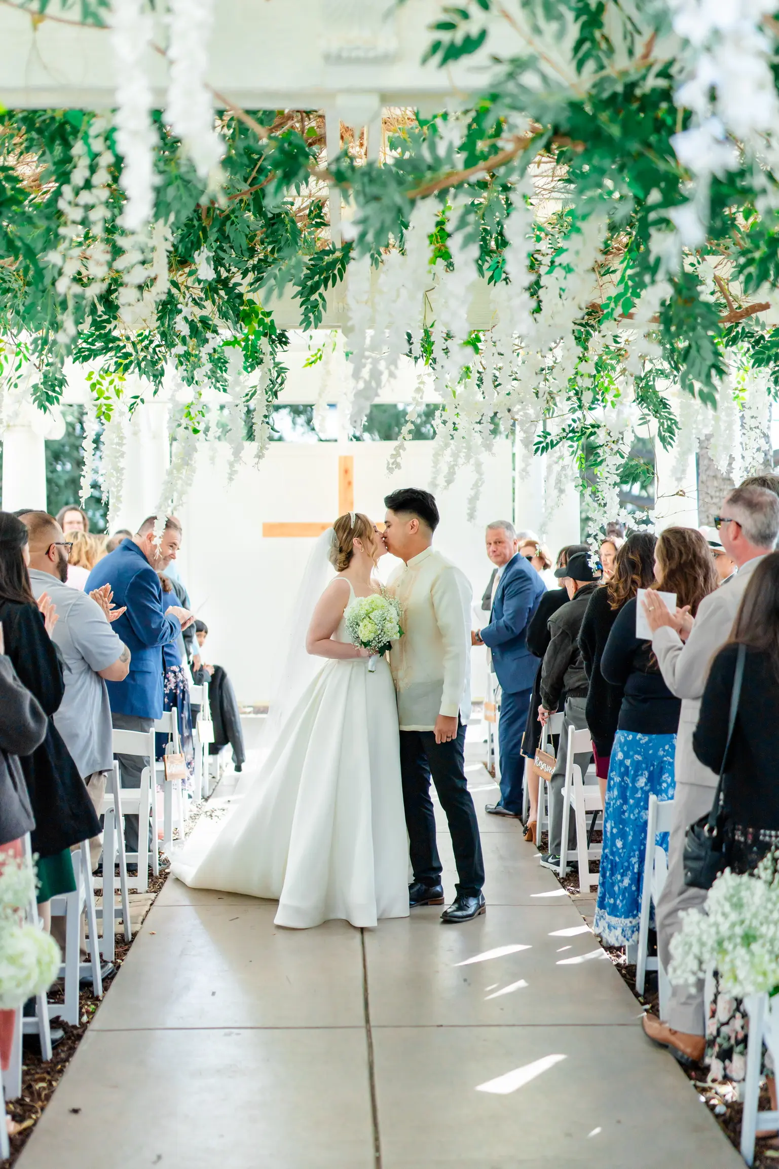 Bride wearing Selena by Maggie Sottero kissing her husband