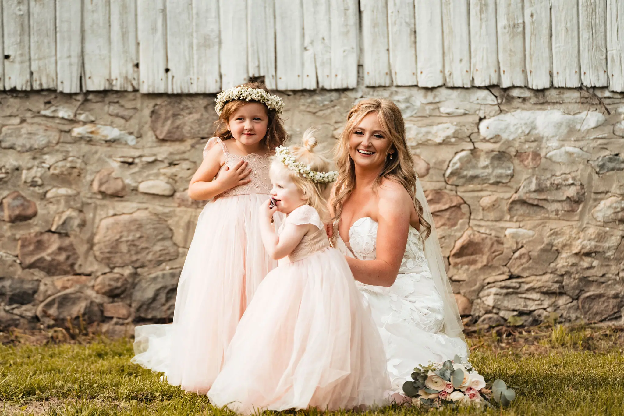 Bride in sparkle tulle wedding dress called Hattie by Rebecca Ingram with flower girls in pink